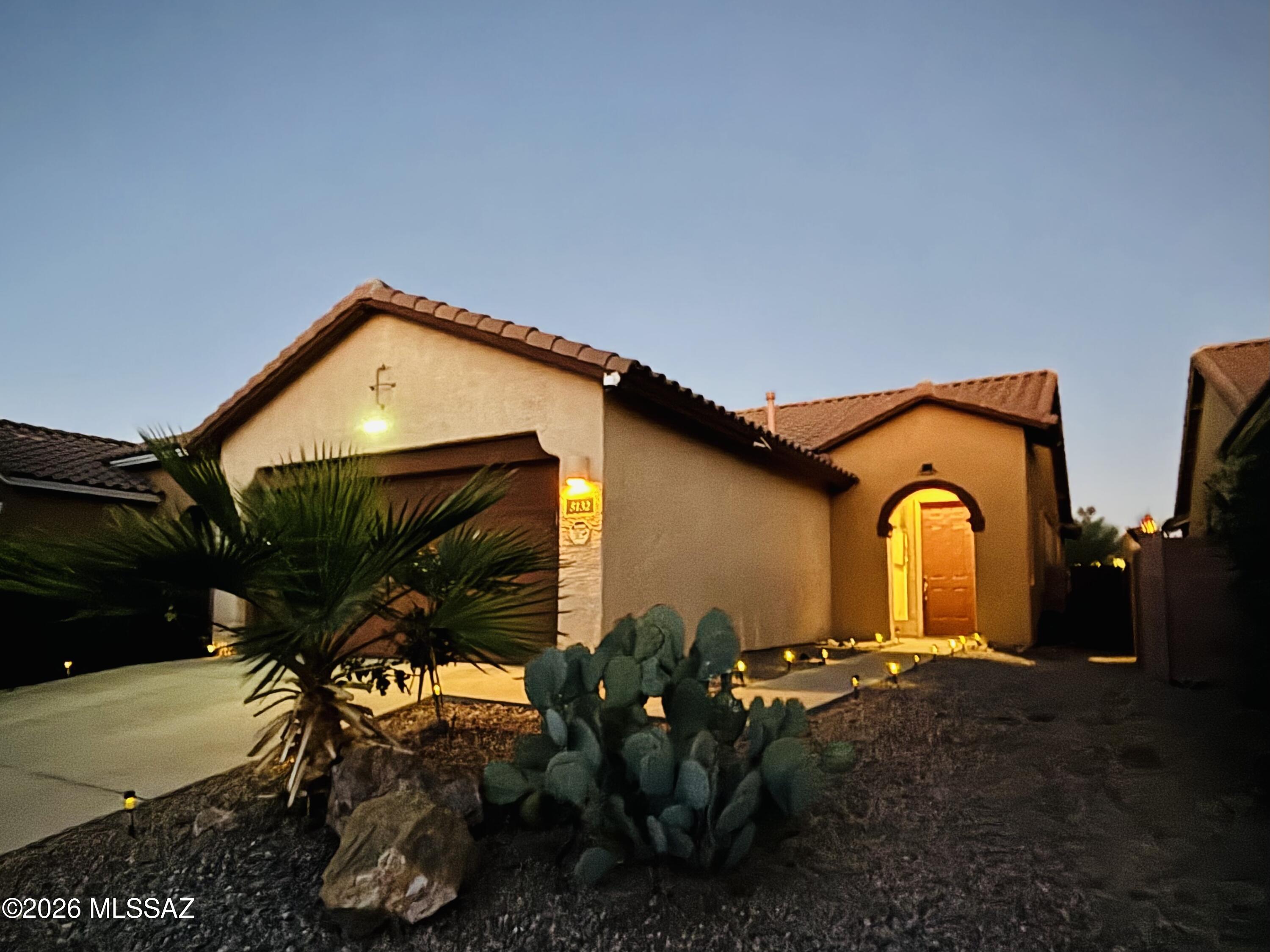 Nestled in a serene, well-maintained community, this move-in-ready 3-bedroom one story home offers the perfect blend of style and convenience. Strategically located near I-10, you are just minutes away from top-tier amenities including Whole Foods, Costco, and NW Hospital.

The interior boasts a soaring great room with high ceilings and expansive windows that flood the home with natural light. Durable tile flooring flows through the main living areas for easy maintenance. Modern upgrades include a brand-new dishwasher and washing machine, ensuring a seamless transition for the new owners.

The outdoor space is a true highlight. Step into a professionally landscaped backyard featuring brand-new pavers and premium artificial turf. A newly installed automatic irrigation system supports th fruit-bearing citrus trees and vibrant red roses, creating a lush, private sanctuary for relaxation and entertainment.