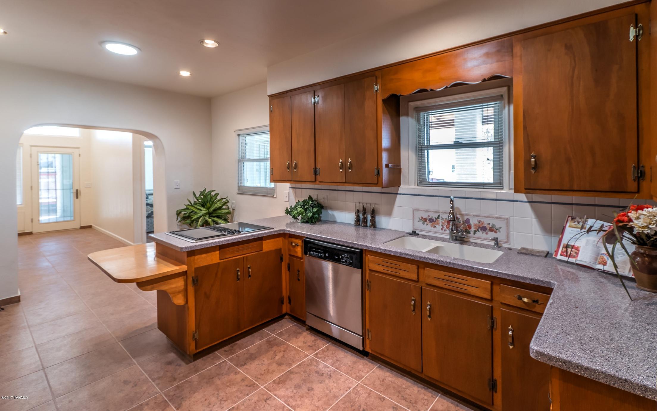 Beautiful 5 bedroom 3 bathroom single-family home within walking distance to the University of Arizona. This  home has modern  amenities with old Tucson charm .this unique home features hard wood floors and ceramic tile thru out.all appliances including washer and dryer.
