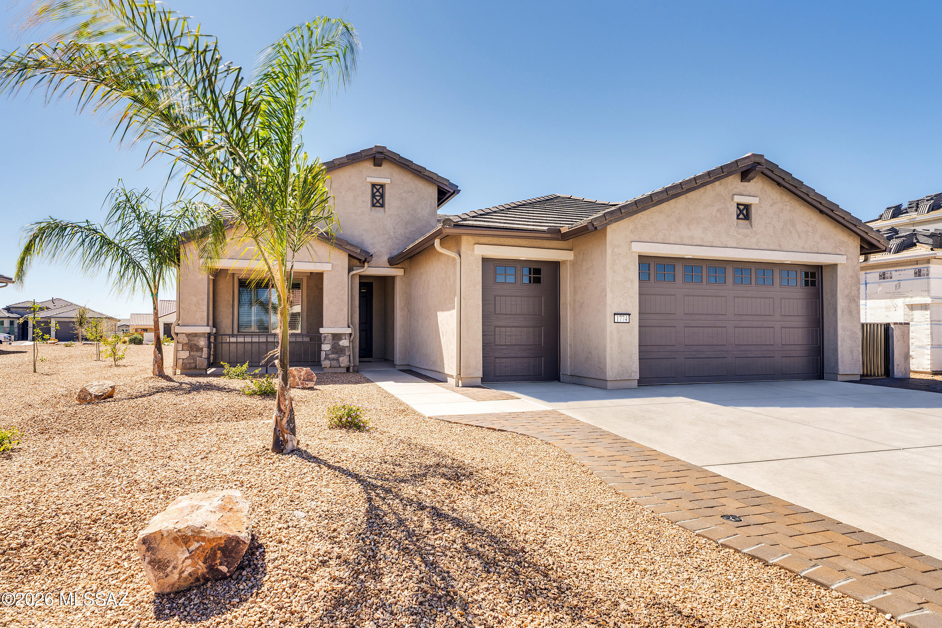 Better than new and beautifully upgraded, this 2025 Mandara model offers 1,884 sq. ft., 2 BR, 2.5 BA plus a den, with completed landscaping, window treatments, and appliances already in place! Just move right in and enjoy! Situated to capture scenic mountain views, this home features outstanding architectural upgrades including a front porch with cool deck coating, a 4' extended-length garage with golf cart bay and epoxy floors, and a 5' extended driveway. Enter through the welcoming foyer accented with crown molding, leading to a den with two-tone paint, crown molding, and recessed-fit plantation shutters. The open-concept great room is filled with natural light, and features a 4-panel center-opening glass slider that connects seamlessly to the rear patio for true indoor-outdoor living. The upgraded kitchen is designed for both everyday living and entertaining, showcasing 41" upper cabinets, quartz countertops, a center island with pendant lighting, composite undermount sink with reverse osmosis, soft-close cabinets and drawers, roll-out shelves, hidden trash bin cabinet, pantry closet, and under- and over-cabinet lighting. A full suite of LG stainless steel appliances, including a gas range, completes the space. The dining area just off the kitchen includes a built-in buffet and recessed lighting for added style and function. Quality finishes continue throughout the home with upgraded fans and lighting, 8' interior doors, and tile flooring in the main living areas. The spacious owner's suite offers a dual-vanity bath, large walk-in closet, and a semi-frameless all-tile shower. The split bedroom plan provides privacy for guests, who will enjoy an en-suite bath, while a separate powder room adds convenience. Designed for comfort and efficiency, the home includes an insulated garage, natural gas tankless water heater with whole-house recirculating pump, 3-stage water filtration system, and upgraded 3-zone heating and cooling for the primary suite, guest suite, and main living area.

Outdoor living is just as impressive, with completed landscaping front and back, a covered rear patio with mountain views and electronic shade screens, citrus trees (grapefruit, orange, and lemon) pet-friendly artificial turf, irrigation, and rain gutters--all backing to common area with no rear neighbors.

Enjoy the best of resort-style living in Quail Creek, where residents have access to world-class amenities including championship golf, resort pools, fitness center, tennis and pickleball courts, clubhouse dining, scenic walking paths, and a full calendar of social activities. This gated active-adult community is designed for comfort, convenience, and an active lifestyle, offering the perfect blend of relaxation, recreation, and vibrant community living.
