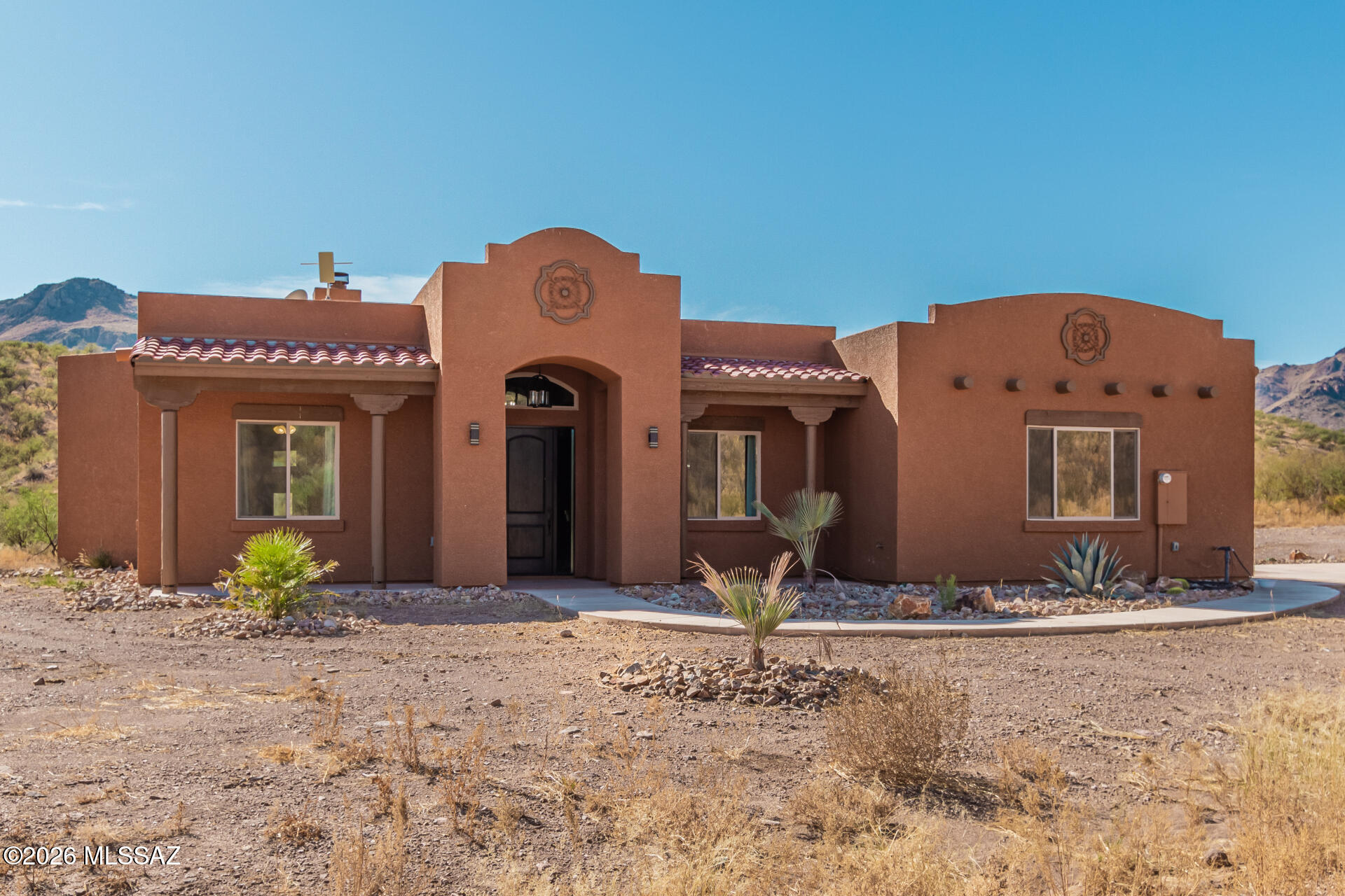 Breathtaking views greet you as you enter this 5.52 acre property. Tis 3 bed/2 bath home boasts 11' ceilings in the living area in the living area and 9' ceilings through out the rest of the home. Beautifully stained exposed beams, stained wood encased windows, a beautiful stone fireplace with a custom wood mantel. 8' stained wooden doors, rustic hickory cabinets and granite counter tops in the kitchen.  The perfect home for relaxing and enjoying the beautiful desert surroundings.  Large windows and double doors open the home to the beautiful mountain views. The back porch is set with pavers and a peaceful pond-less waterfall and lush landscaping. The property is private with no HOA.  Your slice of heaven in the peaceful and beautiful desert of southern Arizona.