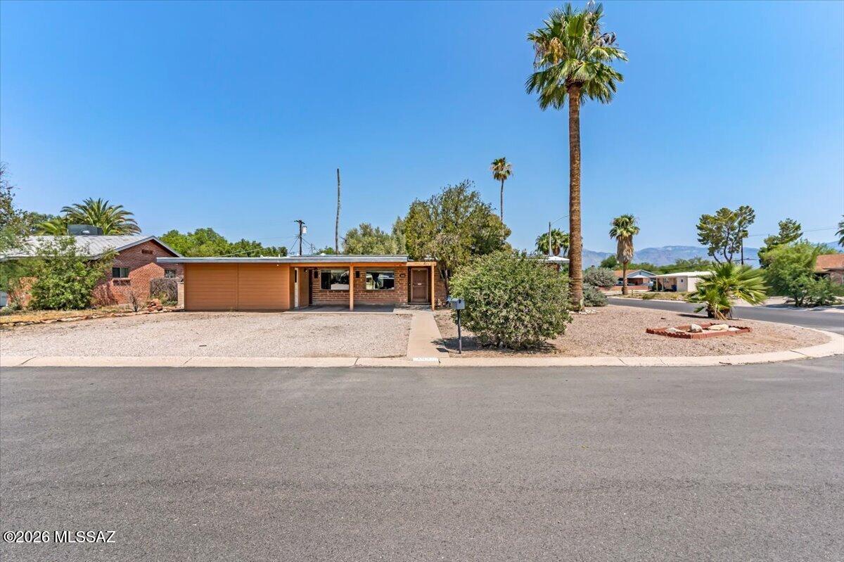 LOW RATE ASSUMABLE RATE 2.99%! Check out this awesome home with great upgrades on a large corner lot in east Tucson! Stunning vaulted exposed beam ceiling and built-in shelving that give the space much warmth and character. Sliding glass doors in the living room and spare bedroom flood the home with natural light. The kitchen shows of with granite counter-tops and a breakfast bar. Plus, you get a 4-year young AC unit and brand-new water heater and outdoor copper piping! Step outside and you'll fall in love with the backyard -- a sprawling partially covered patio perfect for hanging out, a storage shed for extra storage. And it's all just blocks from shopping and restaurants. Enjoy low to no electric bills thanks to the solar panel system!