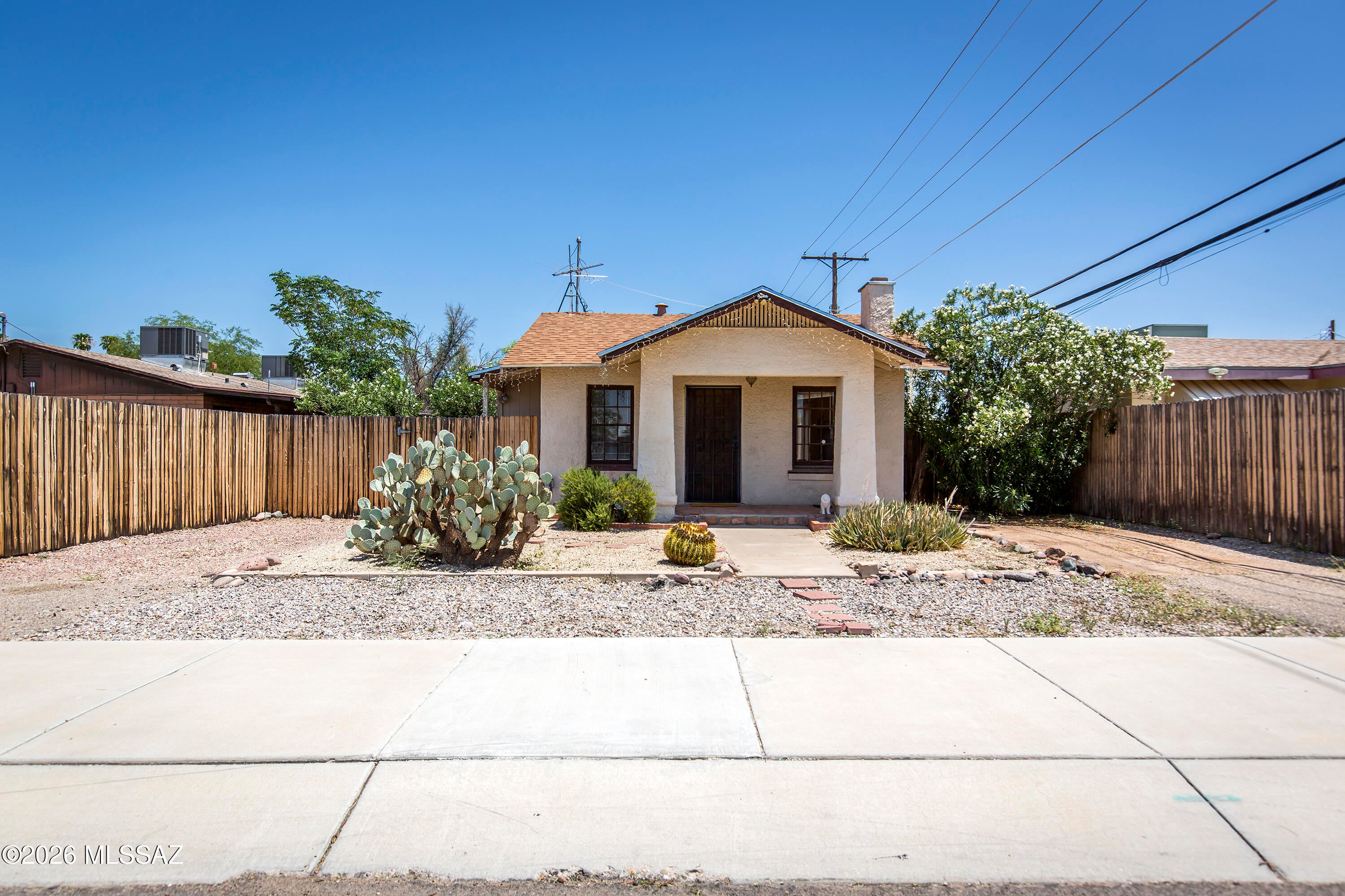 Charming vintage bungalow c. 1927 with a Southwest-style guest house in a prime central Tucson location near the University of Arizona. The 867 sq ft main house features a spacious living area with a fireplace niche, French doors, a galley kitchen, two bedrooms, one bath, and two additional office/flex spaces.

The later-added, separate and spacious guest house offers one bedroom, a great room, high ceilings, and scored and colored concrete floors.

Both homes are full of character and are currently rented, offering an attractive investment opportunity. Off-street parking comfortably accommodates both residences. Conveniently located near the U of A, Downtown Tucson, and the Sunshine Mile.