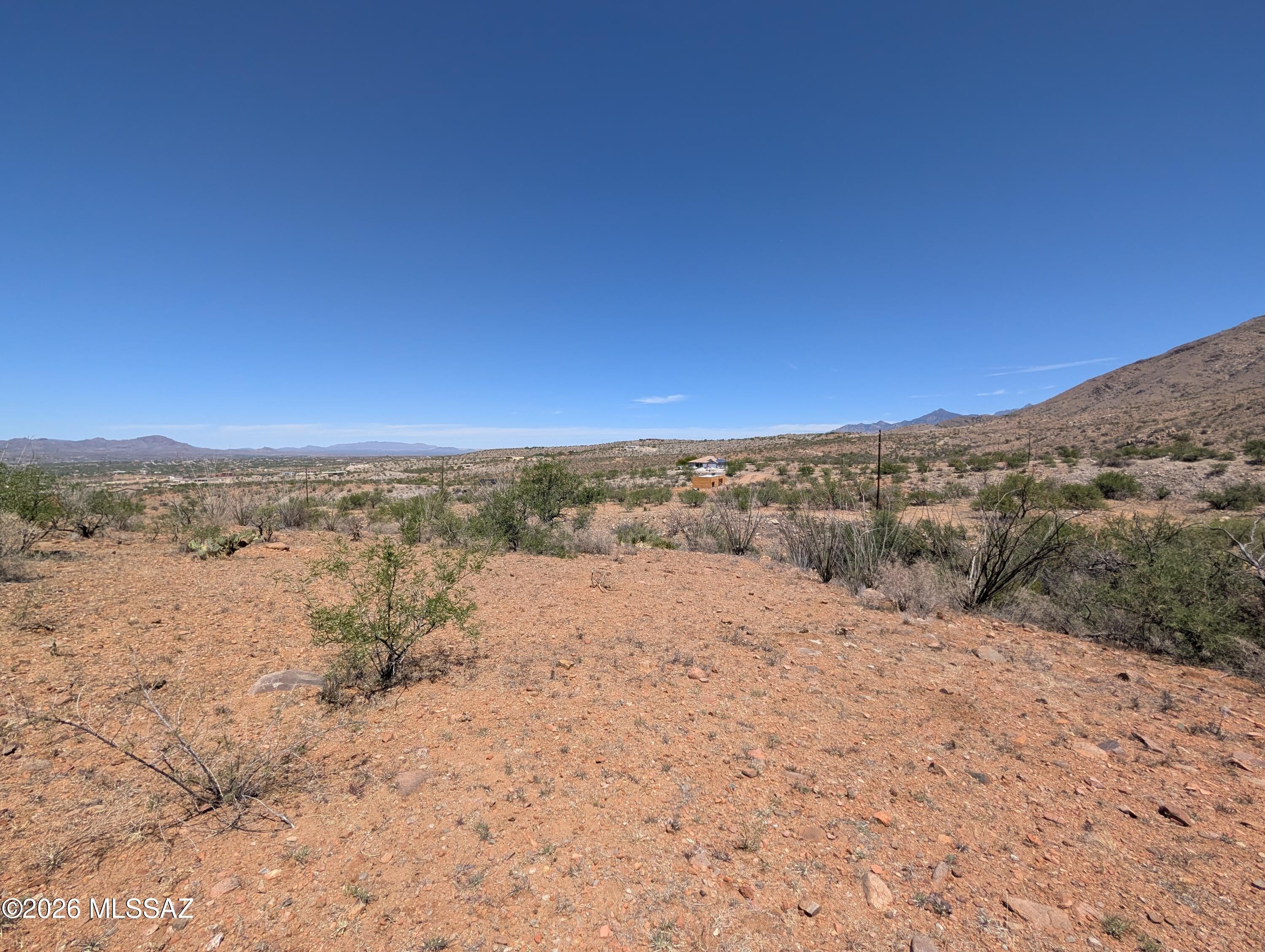 Beautiful residential lot in Rio Rico Ranchettes with expansive mountain views. The property has water and electric at the lot line, making it ideal for a custom home or future investment. Enjoy peaceful surroundings, dramatic sunrises and sunsets, and convenient access to local amenities. The cut-de-sac road is lightly traveled and will see improved maintenance once a building permit is pulled, making this excellent opportunity to secure a scenic homesite with long-term potential. Buyer to verify all information deemed important to buyer.