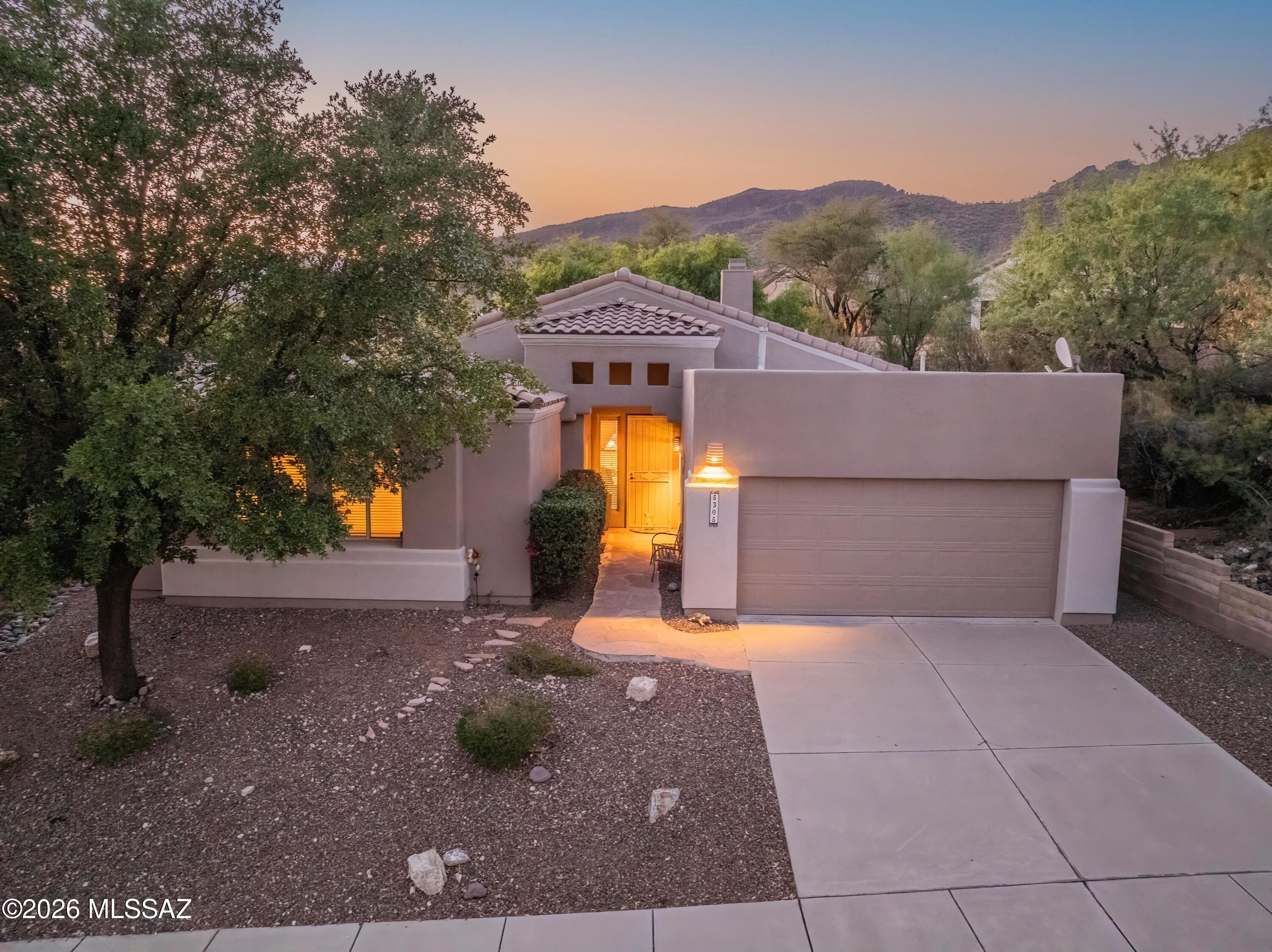 Welcome to this meticulously maintained contemporary home in the prestigious, guard-gated golf community of Sabino Springs. Perfectly positioned in Tucson's desirable northeast side, this beautifully updated residence is in close proximity to the community pool, fitness center, and Arizona National Golf Club, offering an exceptional blend of luxury, comfort, and convenience.
Built in 2000, this 2,036-square-foot home features an inviting open-concept, split-bedroom floor plan with three spacious bedrooms, two full bathrooms, and a versatile den/office ideal for working from home or creating a private retreat. Soaring ceilings, abundant natural light, updated flooring throughout, Hunter Douglas window coverings, and a built-in Sonos sound system with in-ceiling speakers in the kitchen and and dining room create a warm, sophisticated living environment.
The beautifully remodeled kitchen, is the heart of the home and showcases quartz countertops, a designer tile backsplash, a breakfast bar with seating, and LG stainless steel appliances. The spacious great room flows seamlessly to the outdoor living spaces, making entertaining effortless.
The luxurious primary suite offers a spa-inspired bathroom remodeled with quartz countertops, updated flooring, modern lighting and mirrors, and a beautifully redesigned tub and shower. Additional interior updates include a custom tiled fireplace , professionally painted ceilings, freshly painted great room and dining room ceilings (2026), and newly painted kitchen, dining room, and laundry room (2026).
The professionally landscaped grounds features flagstone at both the front entry and backyard patio, an inviting outdoor BBQ area, an irrigation system, and dark exterior sun screens for enhanced energy efficiency. The property has been consistently cared for with professional landscaping every five weeks and regular pest control service.
This home offers exceptional peace of mind with an impressive list of major improvements, including a complete roof replacement with new tile (2017), water heater replacement (2019), HVAC replacement (2020) with a transferable Rite Way maintenance agreement through May 2027, Culligan/Water Tec water softener (2020), garage flat roof replacement by Cervantes Roofing (October 2025) with a transferable 3-year warranty, exterior repainting (January 2026), outdoor water shut-off installation (2024/2025), annual garage door maintenance by A1 Garage Door Service, and meticulous annual preventative maintenance throughout. The washer and dryer, approximately one year old, are also included with the sale.
This move-in-ready home combines timeless style, thoughtful updates, and outstanding maintenance in one of Tucson's most sought-after golf communities. Don't miss this opportunity to enjoy resort-style living in beautiful Sabino Springs.