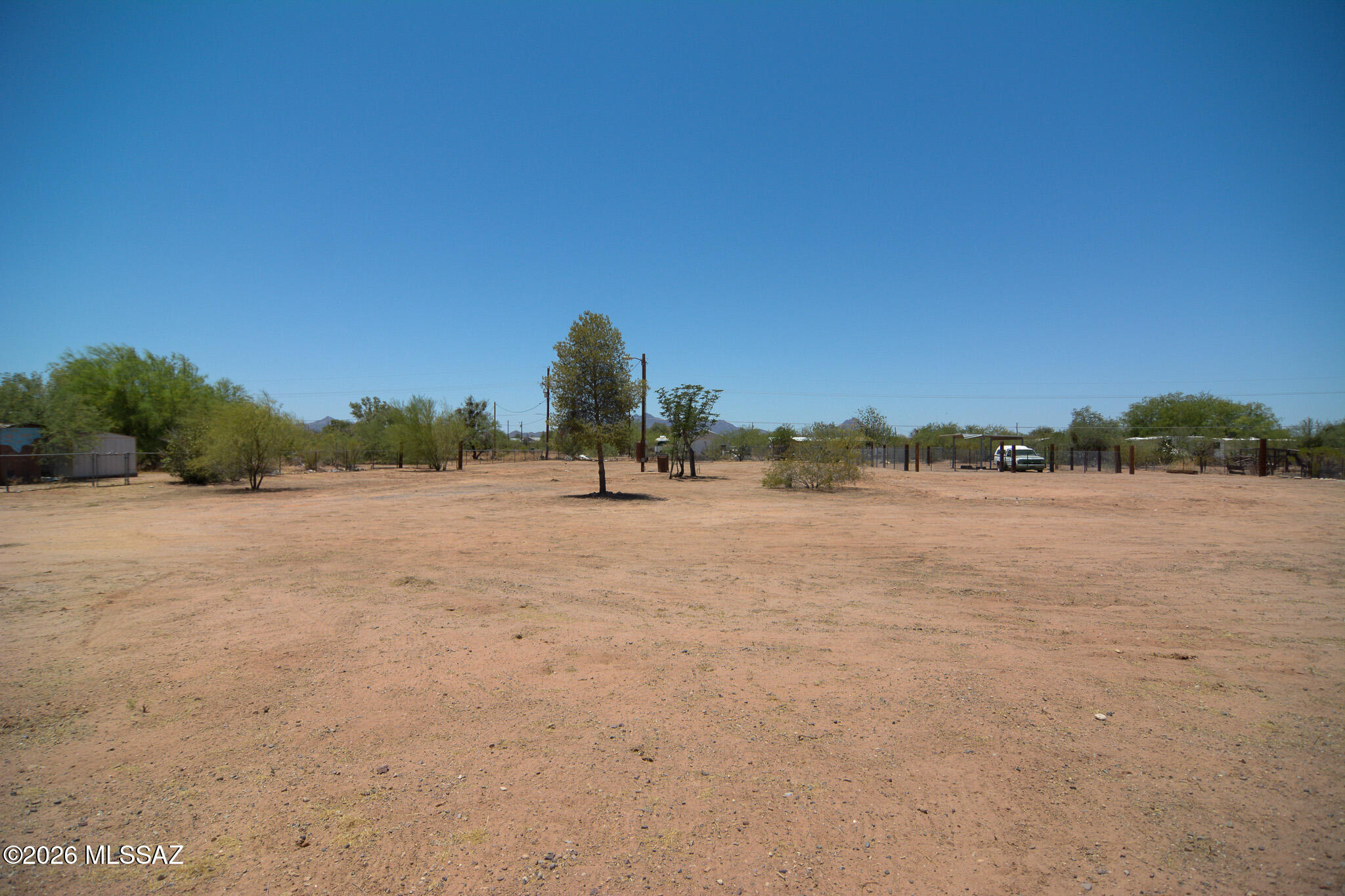 Vacant lot, located in a scenic West Marana location. Beautiful desert landscape. Currently there are 2 trailers on property, but no titles for the trailers. Old private well on lot. Utilities existing onsite: public water, electric, septic. Owner carry available.