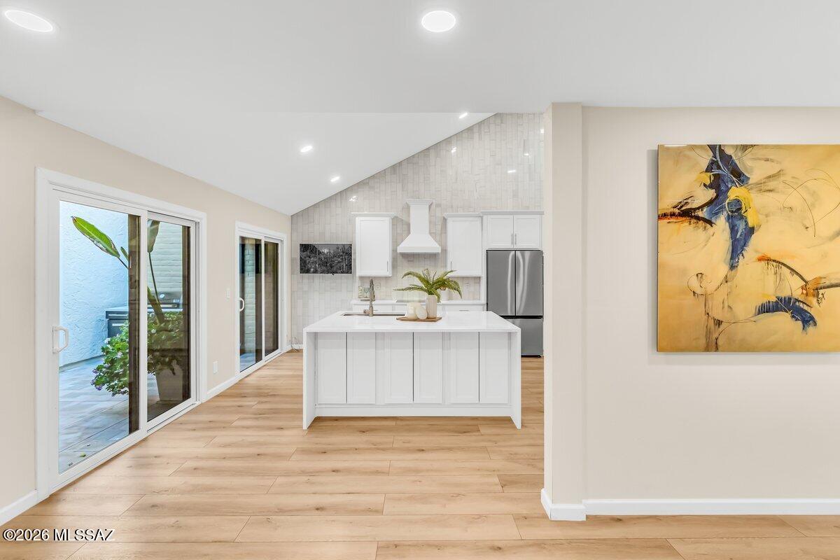 Set within the peaceful Haciendas Catalina del Rey community, this beautifully remodeled residence combines timeless desert surroundings with comfortable, low-maintenance living. From the moment you arrive, a private entry courtyard creates a welcoming sense of arrival. Inside, the open-concept living and dining areas feature soaring ceilings, abundant natural light, and large windows that frame the surrounding mountain and desert scenery. A wood-burning fireplace adds warmth and character to the main living space, creating ideal gathering space for quiet evenings at home or relaxed entertaining with friends. The remodeled kitchen is designed to be both beautiful and functional, flowing naturally into the dining and living areas. With its open configuration and breakfast bar, it becomes the heart of the home- equally suited to a casual morning coffee or an evening spent hosting guests. Both bedrooms offer the comfort of private suites, generous walk-in closets, and beautifully appointed baths. The primary suite provides a particularly tranquil escape, featuring a luxurious oversized dual-head walk-in shower. Thoughtful closet organization adds a level of convenience that makes everyday living feel effortless. Beyond the interiors, the home embraces Tucson's remarkable outdoor lifestyle. A spacious, low-maintenance backyard provides a peaceful setting for morning coffee, sunset cocktails, al fresco dining, or simply taking in the expansive desert and mountain views. With the hard work of landscape maintenance minimized, there is more time to enjoy the lifestyle that makes the Catalina Foothills so special. A two-car garage with additional storage offers practical space for vehicles, recreational gear, and everyday essentials. Residents also enjoy the community's pool, spa, and clubhouse- perfect for cooling off on warm afternoons, unwinding after a day of exploring, or connecting with neighbors. And the location makes it easy to enjoy the best of north-central Tucson. Shopping, dining, outdoor recreation, and the distinctive character of the Catalina Foothills are all close at hand, while the home's setting provides a welcome sense of retreat when you return.

This is more than a beautifully updated townhome; it is an opportunity to embrace a relaxed, refined Tucson lifestyle surrounded by natural beauty, thoughtful design, and everyday convenience.