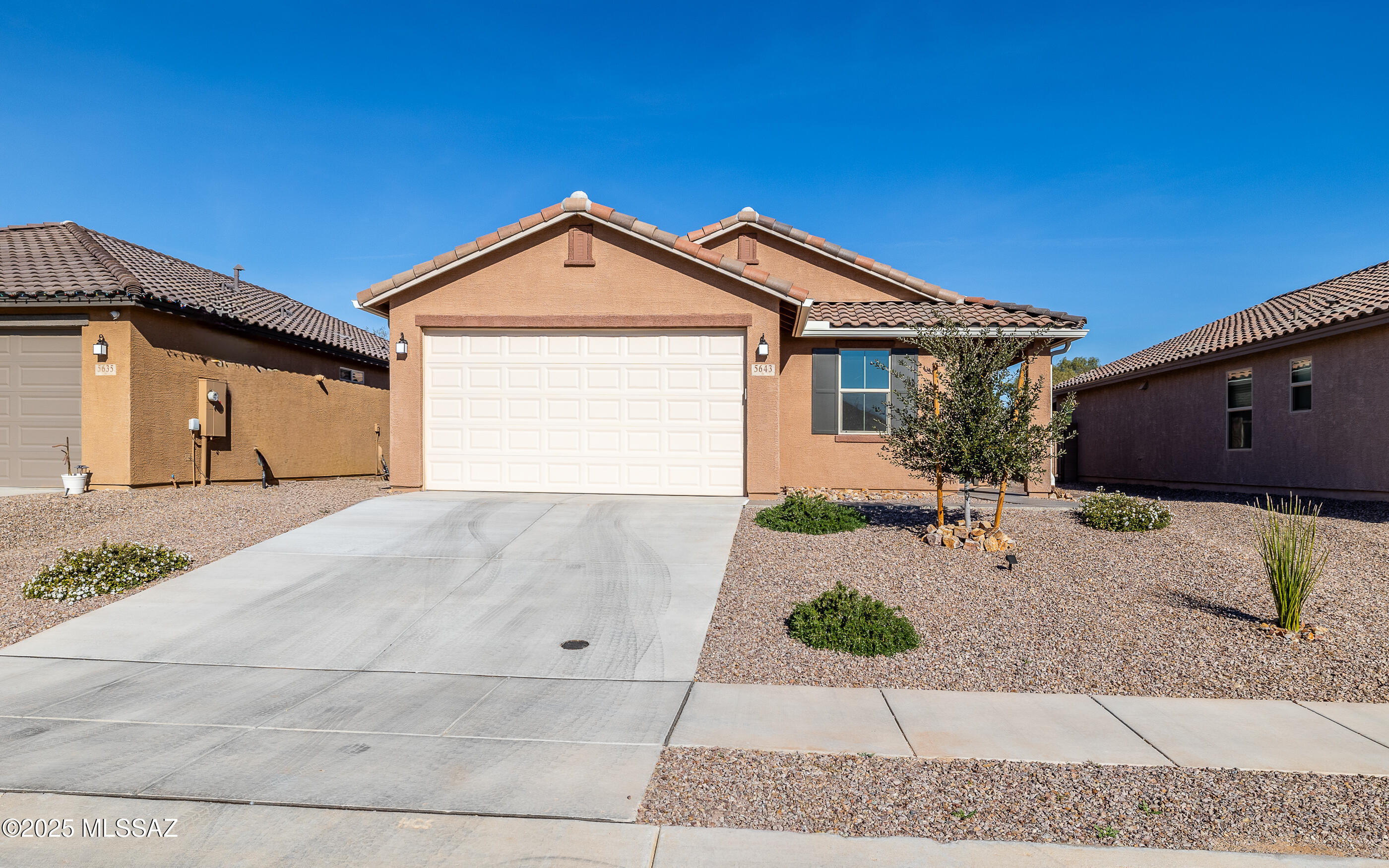 Motivated seller, price reduced by $40k! New construction home, 3 bed/2 bath with $100,000+ in upgrades. Yard build-out already completed with pavers, turf, firepit, and Bullfrog hot tub. There is a 2-car garage w/epoxy floors and overhead storage racks. The exterior has a gorgeous tile roof, gutters, epoxy walkway, covered front patio, 8' entry door, and beautiful landscaping with irrigation system. The interior has NO carpet, uniform 6'' x 24'' porcelain tile throughout, 9' ceilings, solar blinds, modern light fixtures, and smart thermostat/doorbell. Kitchen appliances are Whirlpool stainless steel, Silestone quartz counter tops with 4'' backsplash, 42'' upper cabinetry, and island with sink. Washer/Dryer/Fridge/Hot Tub conveys. MUST SEE VIDEO & UPGRADE LIST!!