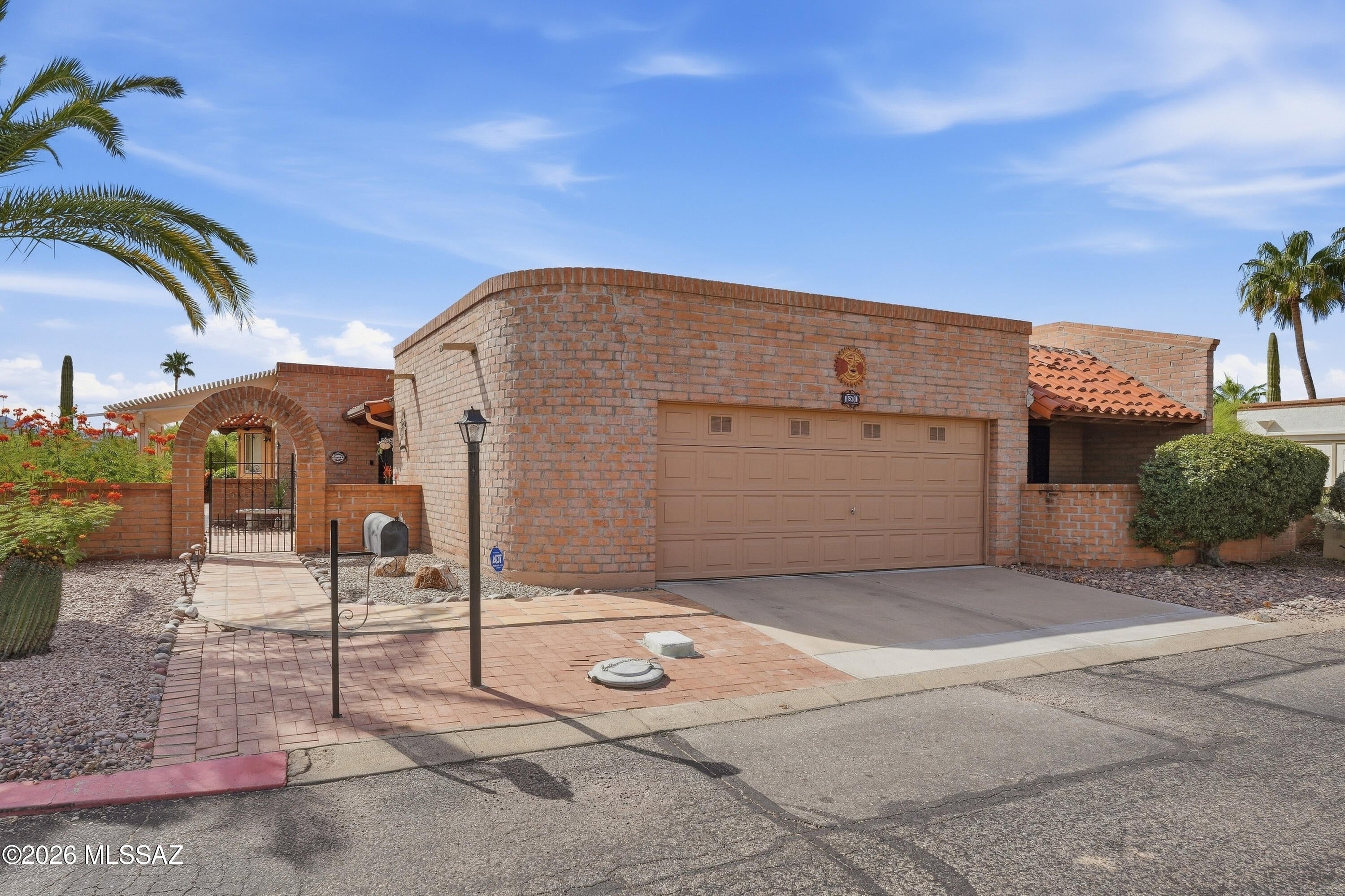 Desert Hills V. Spacious Miramar floorplan of 2,050 sf, and Santa Rita Mountain views. Welcome to a home where Southwest character, comfortable living, and beautiful outdoor spaces come together for desert leisure and relaxation. The charming brick exterior, attractive landscaping, and hacienda-inspired gated archway create a lasting first impression. Inside, thoughtfully designed Miramar a highly sought Fairfield floor plan.  Windows and sliding glass doors enhance the abundant wrap around natural light cascading within. 
At the heart of the home is a bright, updated kitchen featuring Shaker-style cabinetry, sparkling white subway tile backsplash, modern appliances, and a convenient breakfast bar Enjoy casual meals in the sun-filled eat-in kitchen area, gather beneath the farmhouse-style chandelier, or entertain in the adjoining formal dining room. This inviting home complete with a versatile private den/office/3rd bedroom offering flexible space.
Sliding glass doors provide a natural connection between the kitchen dining area and the covered outdoor patio, making indoor-outdoor dining and entertaining effortless.
The primary suite is a peaceful retreat, filled with natural light and featuring a colorful accent wall, private patio access through wrought iron security, double sliding glass doors and the updated ensuite bathroom with a walk-in shower. The guest bedroom also offers sliding-door access to its own private patio, while the updated guest bathroom features a convenient tub and shower combination. 3rd bedroom is flexible, office/den, double doors, private. Step outdoors and enjoy multiple patio areas, easy-care landscaping, and beautiful views of the Santa Rita Mountains and golf course surroundings in this friendly neighborhood. Sipping morning coffee, dining outdoors, or relaxing at the end of the day, the home's outdoor spaces invite you to enjoy the Southern Arizona lifestyle. Conveniently located near shopping, Desert Hills Green Valley Recreation Center, Presbyterian Church, Elks Lodge, and I-19 access, this thoughtfully designed home brings together location, space, Southwest character, and indoor-outdoor living. Come experience the warmth, charm, and mountain views this lovely Green Valley home has to offer.