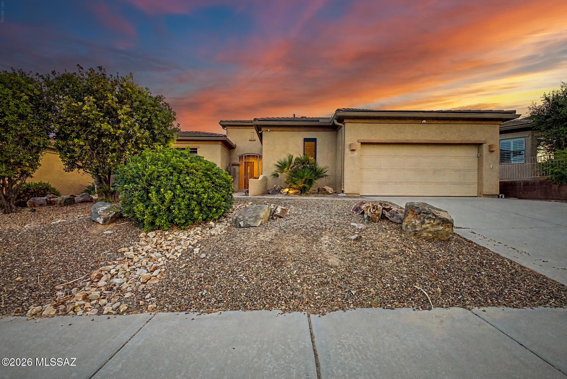 Arizona living with beautiful mountain views! Don't miss this highly upgraded, former model home with a new roof, 3-car garage (with AC) & private courtyard entrance. Designed with both function and comfort in mind, this home features upgraded appliances, granite countertops, glass-front cabinetry, tiled backsplash, under-cabinet lighting and abundant storage throughout. The den with double doors is tucked away provides a flexible space for a home office or hobby room. The third bedroom is a private guest suite with its own entrance and ensuite bath, creating a comfortable retreat for guests. And don't miss all the features in the garage, it is a fully-finished workshop with central vac, air conditioning EV charging and built-in cabinets to maximize the space. The backyard is designed for enjoying Arizona living, featuring a pool, spa, built-in BBQ, north/south exposure, and mountain views. With no neighbors directly behind the property, you'll enjoy added privacy and open desert views that are difficult to find