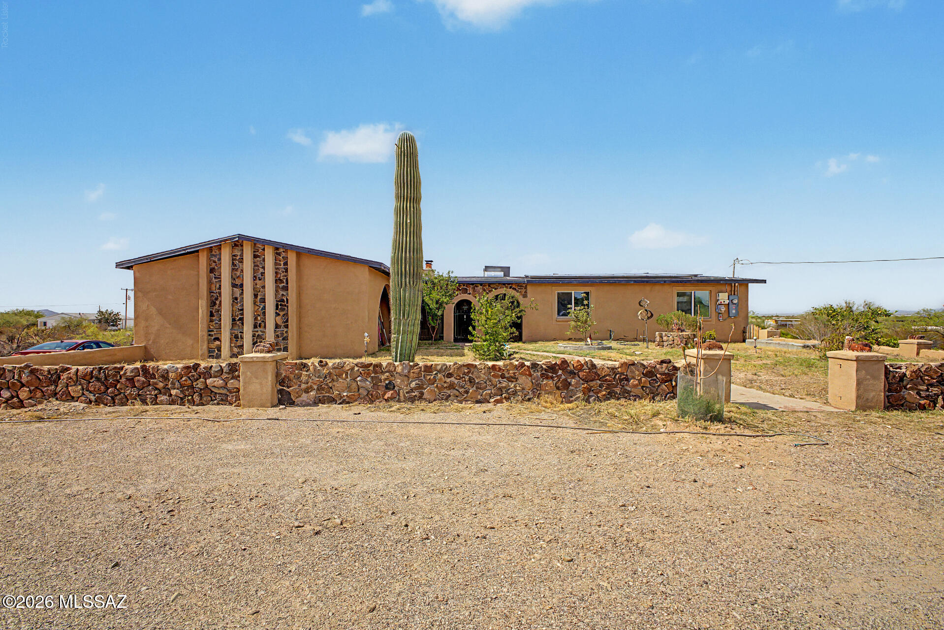 Fantastic opportunity to own this spacious 4-bedroom, 2-bath home offering 2,155 square feet of living space on 4.89 acres with the added benefit of solar! The inviting interior features a cozy living room with wood-look flooring, a fireplace, and abundant natural light. The eat-in kitchen offers white shaker cabinets, recessed lighting, pantry storage, and built-in appliances. A versatile bonus room provides the perfect space for an office, playroom, or media room. Primary suite includes a private bath and walk-in closet. Peaceful outdoor living with a full-length covered patio, mountain views, large chicken coop area, and several mature fruit trees, including dwarf peach trees in the front. Plenty of room for animals, gardens, RVs, or your dream homestead and energy efficiency