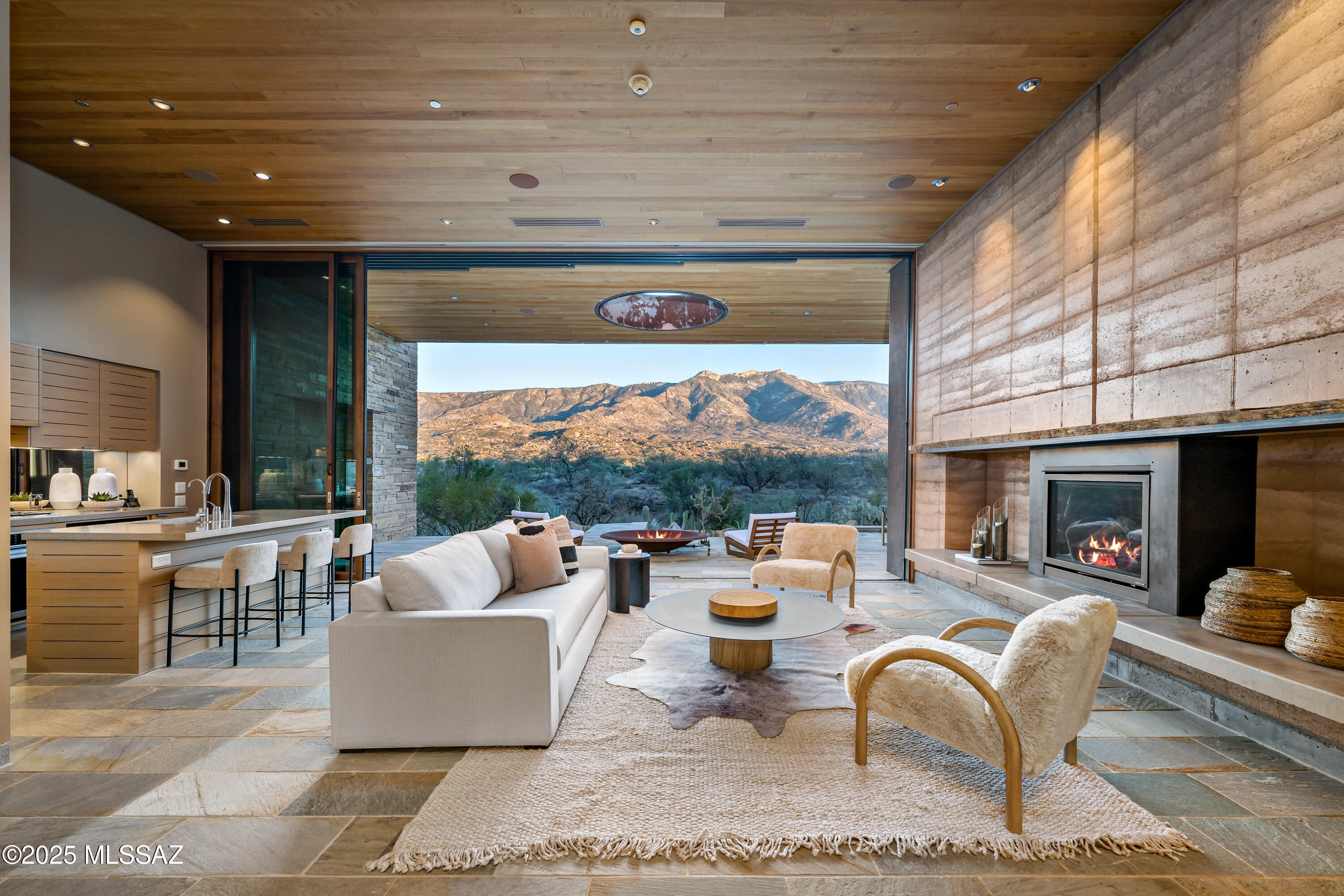 An Elevated Villa at The Villas at Miraval Resort & Spa. Set in one of the most desirable positions within the enclave, this Villa stands apart with its elevated placement and unobstructed Santa Catalina Mountain views--offering a level of privacy, light, and perspective that few others achieve. A peaceful courtyard framed by native desert plantings leads into a dramatic great room, where high ceilings and floor-to-ceiling triple-pane glass doors draw the outdoors in. The seamless transition to the stone-wrapped patio and private pool, creates an effortless indoor-outdoor experience, further enhanced by the Villa's commanding vantage point.
The open kitchen, dining area, and living space support both quiet daily living and easy entertaining. Each bedroom serves as a private retreat with natural materials and spa-inspired baths that reflect the home's thoughtful design. A beautifully designed casita adds another level of flexibility and comfort. Complete with its own living room, bedroom, fireplace, and private hot tub, this space offers an ideal setting for guests to enjoy privacy and independence while remaining connected to the property. 
Designed by Mithun of Seattle with interiors by Clodagh of New York, the Villa reflects a refined, modern aesthetic that incorporates rammed earth, stacked stone, and reclaimed wood. The home is Silver LEED-certified, pairing architectural quality with environmental intention. 
Since ownership, the seller has maintained the property with exceptional care , replacing appliances, HVAC systems, and the generator, updating the water heater, and keeping the home in meticulous condition throughout. Ownership includes professional on-site management and optional rental opportunities for true lock-and-leave convenience. Residents enjoy full access to Miraval's award-winning amenities, including the Life in Balance Spa, wellness programs, and acclaimed culinary offerings. 
This Villa is not just a residence; it is a rare and elevated retreat within Miraval, distinguished by its setting, design, casita, and exceptional stewardship.