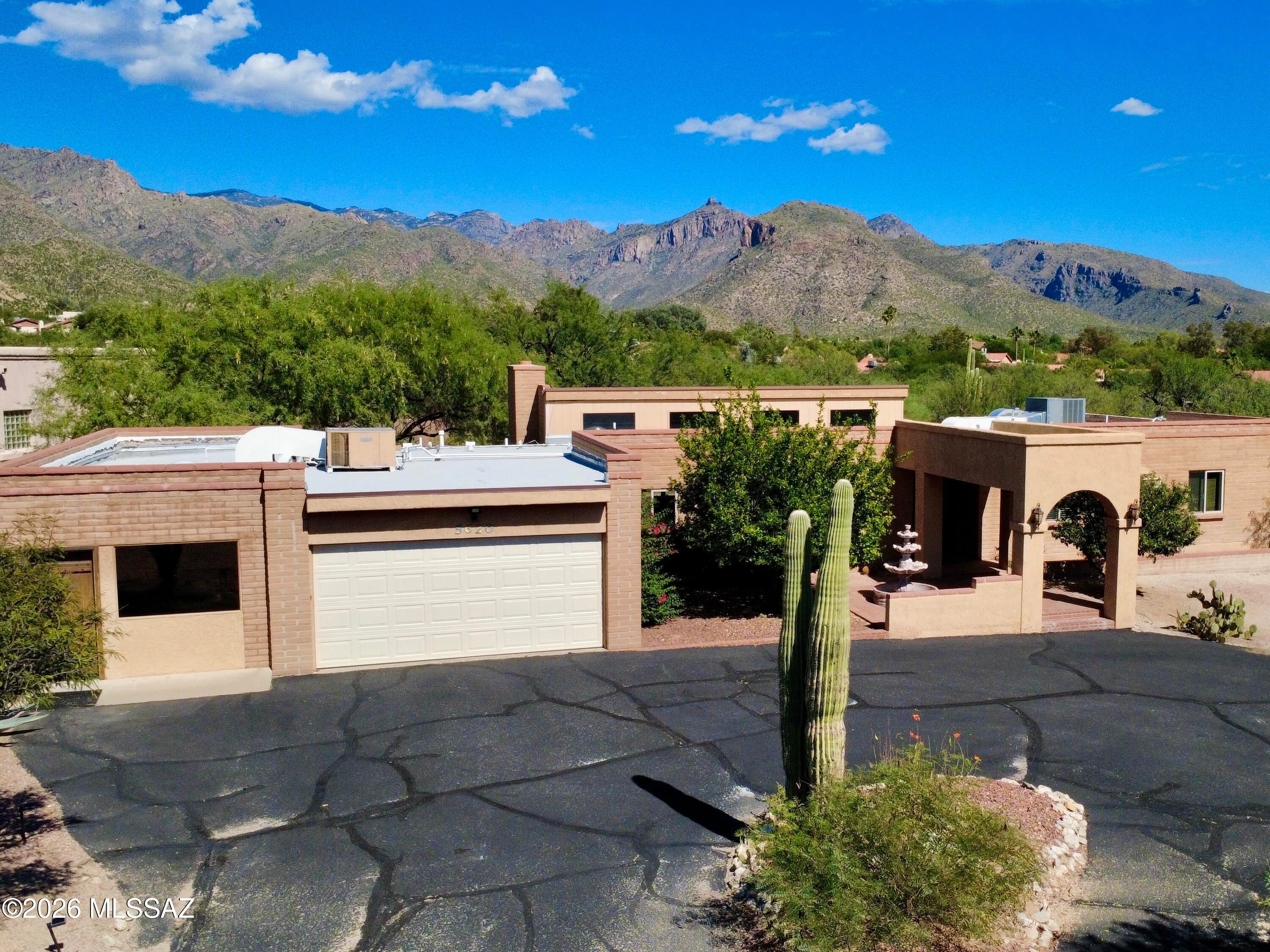 MOTIVATED SELLER! Bring ALL offers! Location, location, location! Just minutes from Sabino Canyon, this spacious Catalina Foothills home offers over an acre of privacy, mountain views, and NO HOA. Bring your RV, toys, and imagination--there's plenty of room to make this property your own!

Inside, large windows fill the home with natural light, while high ceilings and a beautiful brick fireplace create a warm and inviting living space. The flexible floor plan offers 3 bedrooms, 2.5 bathrooms, and multiple versatile living areas with plenty of room to spread out, entertain, work from home, or create spaces that fit your lifestyle.

The property offers 2,773 sq. ft. of combined living space, including a 2,075 sq. ft. main house plus an additional 698 sq. ft. space ideal for a home offi guest quarters, studio, gym, or in-law suite. Recent improvements include a newer roof, water heater, Milgard front windows with remaining warranty, and a recently seal-coated driveway.

Set on 1.13 acres in an established Foothills neighborhood, you'll enjoy space, privacy, Catalina Mountain views, and easy access to shopping, dining, and the Sabino Canyon Recreation Area--all within the Catalina Foothills School District.