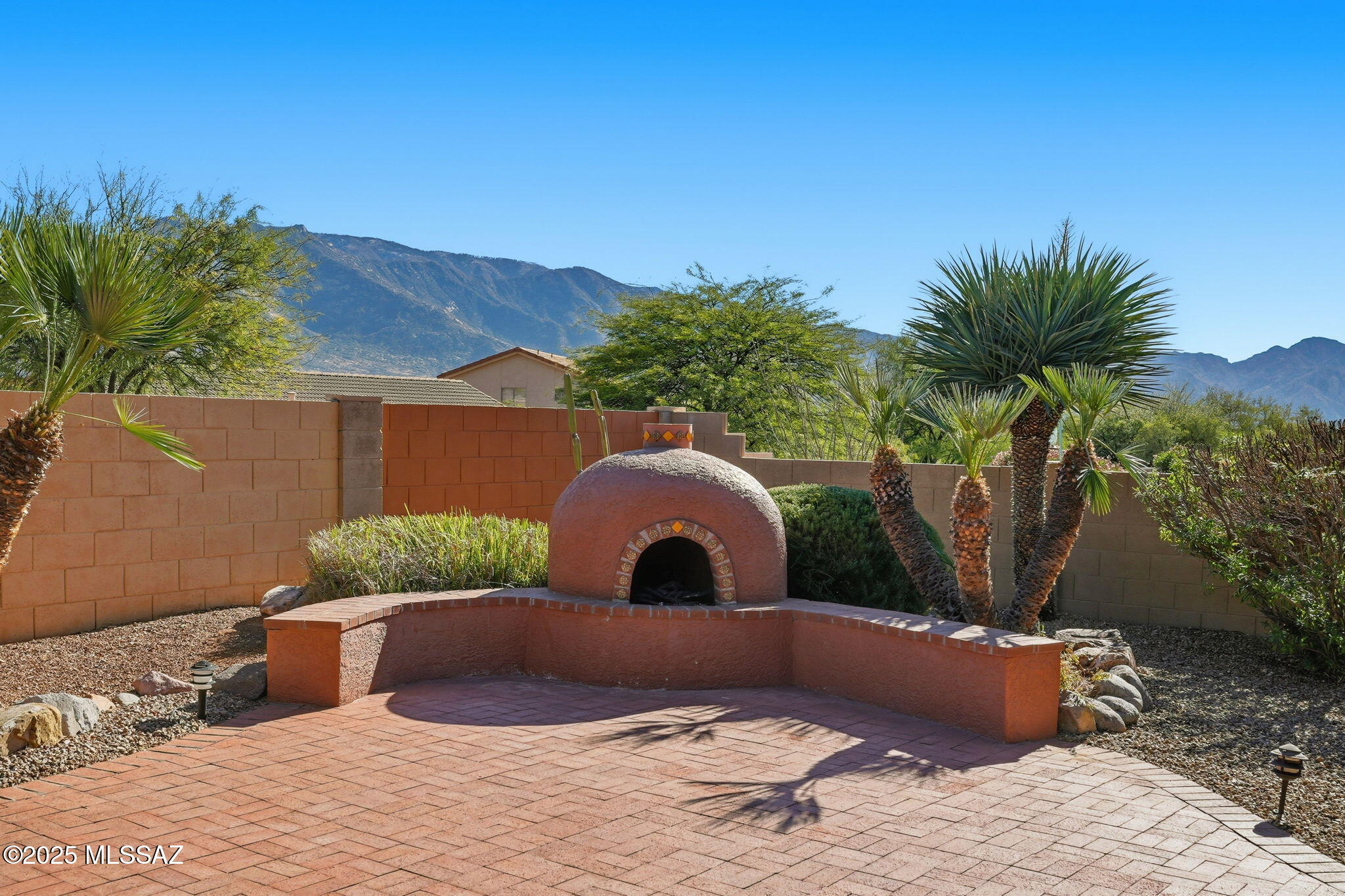 Exceptional east-facing mountain views from this lovely, well-appointed 3 bedroom, 2.5 bath Cheyenne model, w/split bedroom floor plan & bright, open living! Family room & island kitchen boast mountain views, warm cherry cabs, Quartz counters, tile backsplashes, under counter lighting, gas stove, newer appls & large pantry cab w/pull out shelves. Adjacent wet bar features Quartz counters & SS sink. Double door entry to primary suite features bay windows w/mountain views, built-in bookcases, double vanities, 2 large walk-in closets, tiled shower & soaking tub. Two private guest bdrms & full bath, nicely sized living & dining areas, convenient powder room & large laundry room. Spacious covered brick patio w/one column removed for improved mountains views, lovely fountain & kiva FP w/seating. New roof in 2025!