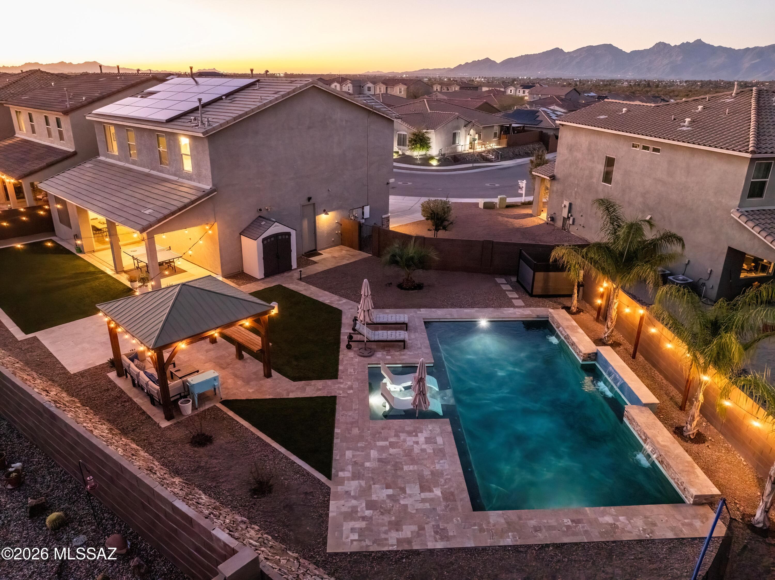 Luxury Living with Scenic Views and Backyard Dream Oasis. Welcome to this stunning Eastside retreat offering 3 bedrooms, 2.5 baths, 3 car garage, plus a dedicated office/den/flex room and spacious loft--designed with both comfort and versatility in mind. Situated on a private premium lot, this home captures beautiful mountain views and effortless indoor-outdoor living. Come inside to soaring ceilings, a dramatic foyer, and an open-concept layout filled with natural light. The gourmet kitchen is one of the showstoppers of the home, featuring an oversized island, microwave, ovens, a large gas cooktop, and abundant storage--perfect for entertaining or everyday living. Stylish tile and carpet flooring, high-end finishes, and thoughtful upgrades throughout create a home that feels both elegant and welcoming. Energy-efficient living meets modern convenience with Owned Solar panels and EV charging, offering sustainability without compromise. The backyard is truly a private resort-style oasis. Enjoy a sparkling pool with three waterfalls and lagoon-style features, surrounded by pavers, artificial turf, and multiple outdoor living spaces. A large, covered patio, gazebo, firepit, and twinkling evening lights create the perfect setting for relaxing nights or unforgettable gatherings. Located in the highly acclaimed Vail School District with direct access to the additional community pool and parks, this home offers easy access to outdoor adventure while being just minutes from shopping, dining, and convenient commuting routes. A rare opportunity to own a home that blends luxury, lifestyle, and location--all in one remarkable property.