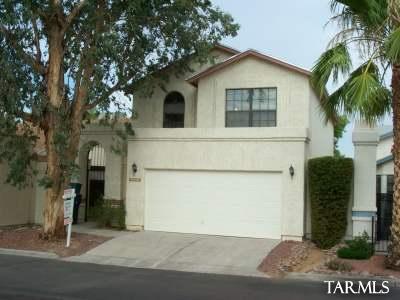Below market rent! Look now or cry later!! Contact Broker for E-Z show! 520-529-3400. Single family 2 story with security gate to porch entrance and main door to home. Private indoor entrance from garage to home. Spacious interior, high ceilings, kitchen appliances, and double garage with opener. Half bath downstairs. New interior paint and flooring. A MUST-SEE HOME! Cool off in community pool during the hot summer. Nice, covered patio porch with walled in rear yard. NO SMOKING IN OR ON PROPERTY! Rental tax added to rent, when applicable.