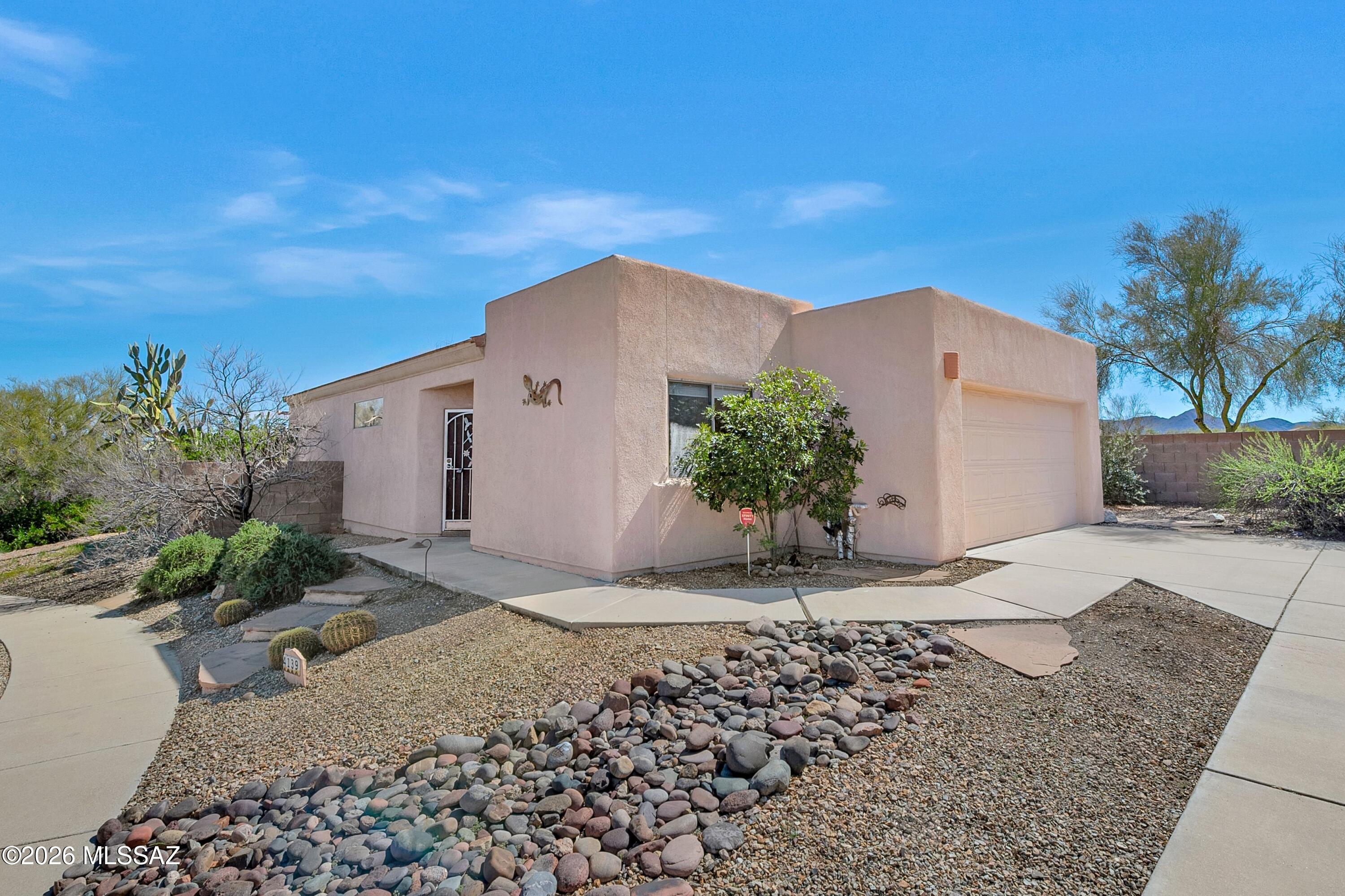 Located on a premier cul-de-sac lot, this well-maintained Tucson home offers privacy, desert surroundings, and comfortable open-concept living. The property backs to natural desert landscape, providing a peaceful setting and enhanced backyard privacy.

Inside, the home features a spacious and functional floor plan with abundant natural light throughout, complemented by new interior paint and recessed lighting that create a bright, updated feel. Wood laminate flooring runs through the main living areas, adding warmth and continuity throughout the home.

The kitchen offers ample cabinetry, generous counter space, stainless steel appliances, and a convenient breakfast bar that opens to the dining and living areas - ideal for both everyday living and entertaining.