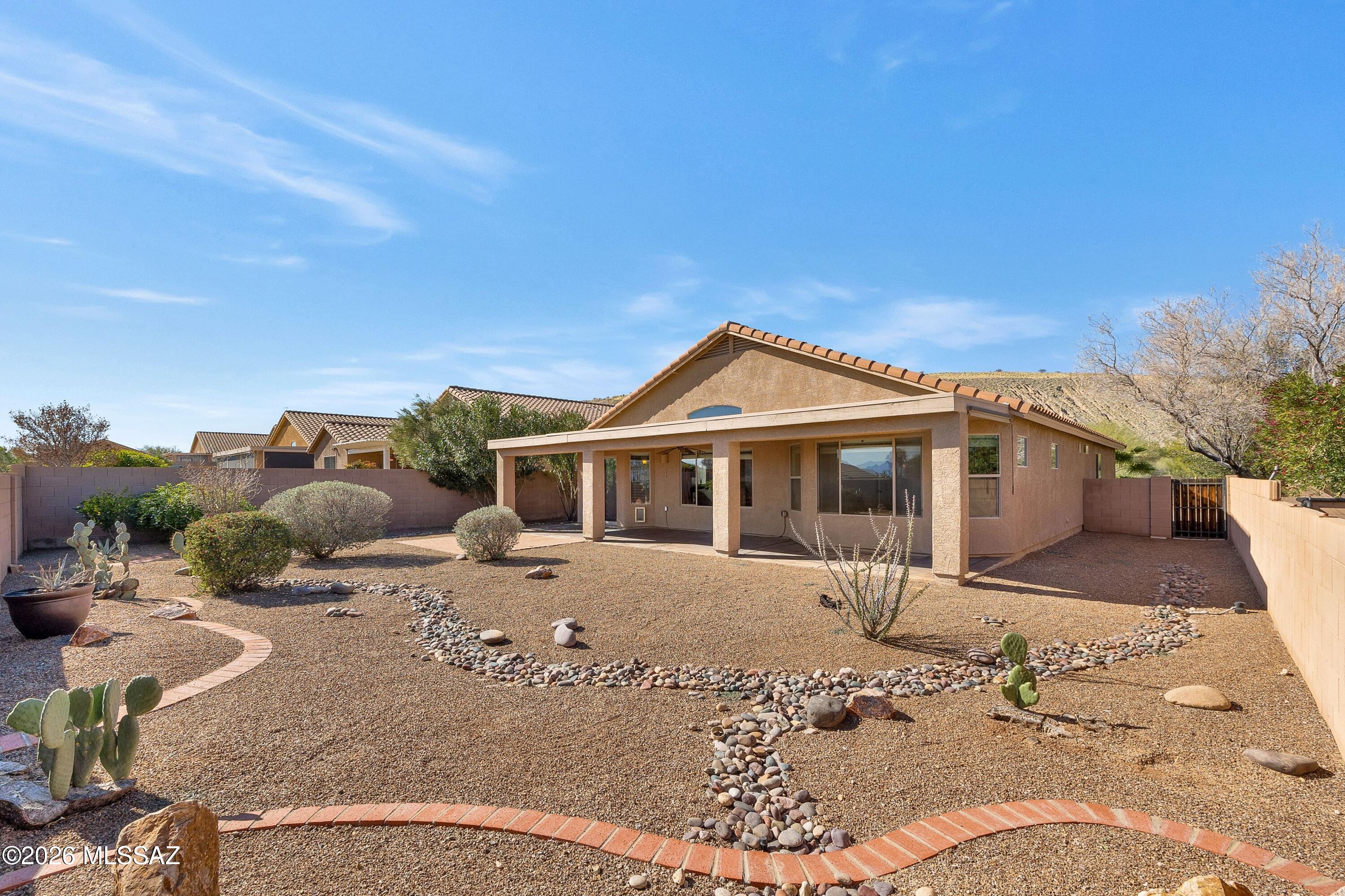 This is one you need to see in person! This elevated lot hides the neighbors below while allowing the views of the Santa Rita Mountains to steal the show! Spacious, fully landscaped, low care backyard with full length patio to enjoy our amazing weather & views. Step inside to this efficiently designed great room floorplan. The kitchen opens to the living and dining area with views out to the backyard. New carpet in the bedrooms and den, tile throughout the rest of the house. Located at the north end of Green Valley, you aren't far from Tucson but still within the Green Valley Rec area to enjoy all the 55+ amenities, like classes, pools, pickleball & tennis and a club for just about all of your favorite hobbies! Visit gvrec.org to learn more about all the community has to offer!