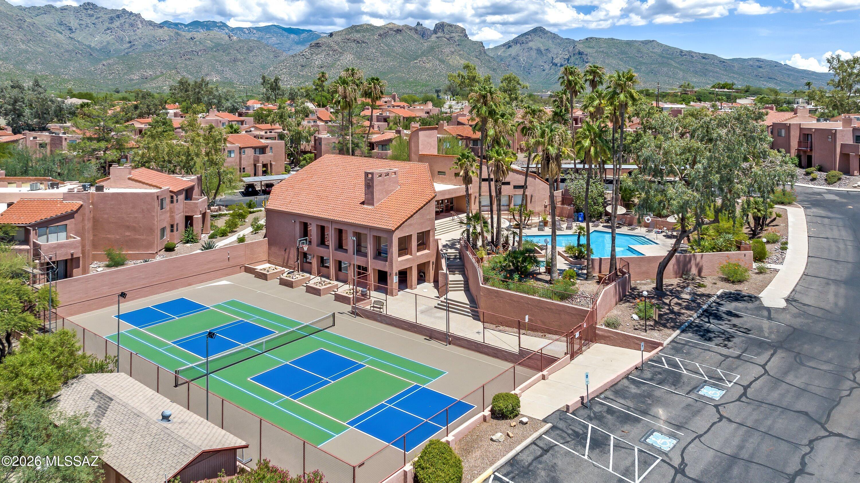Experience luxury desert living in this spacious corner unit Northern Tucson condo with breathtaking Catalina Mountain views.  This beautifully appointed second floor property is located just down the street from Sabino Canyon Park and features an open floor plan with high ceilings and an abundance of natural light. cozy wood burning fireplace, private primary suite with roomy walk-in closet and dual sinks, remodeled kitchen with stainless steel appliances and Corian countertops, laundry room w/ washer / dryer and easy access to shopping & restaurants. The Ventana Vista Condos include a heated pool & 2 spas, tennis / pickleball court with organize play, clubhouse w/ gym, game room & library, on site manager, loads of community activities and roughly 20 acres of pristine desert landcaping.