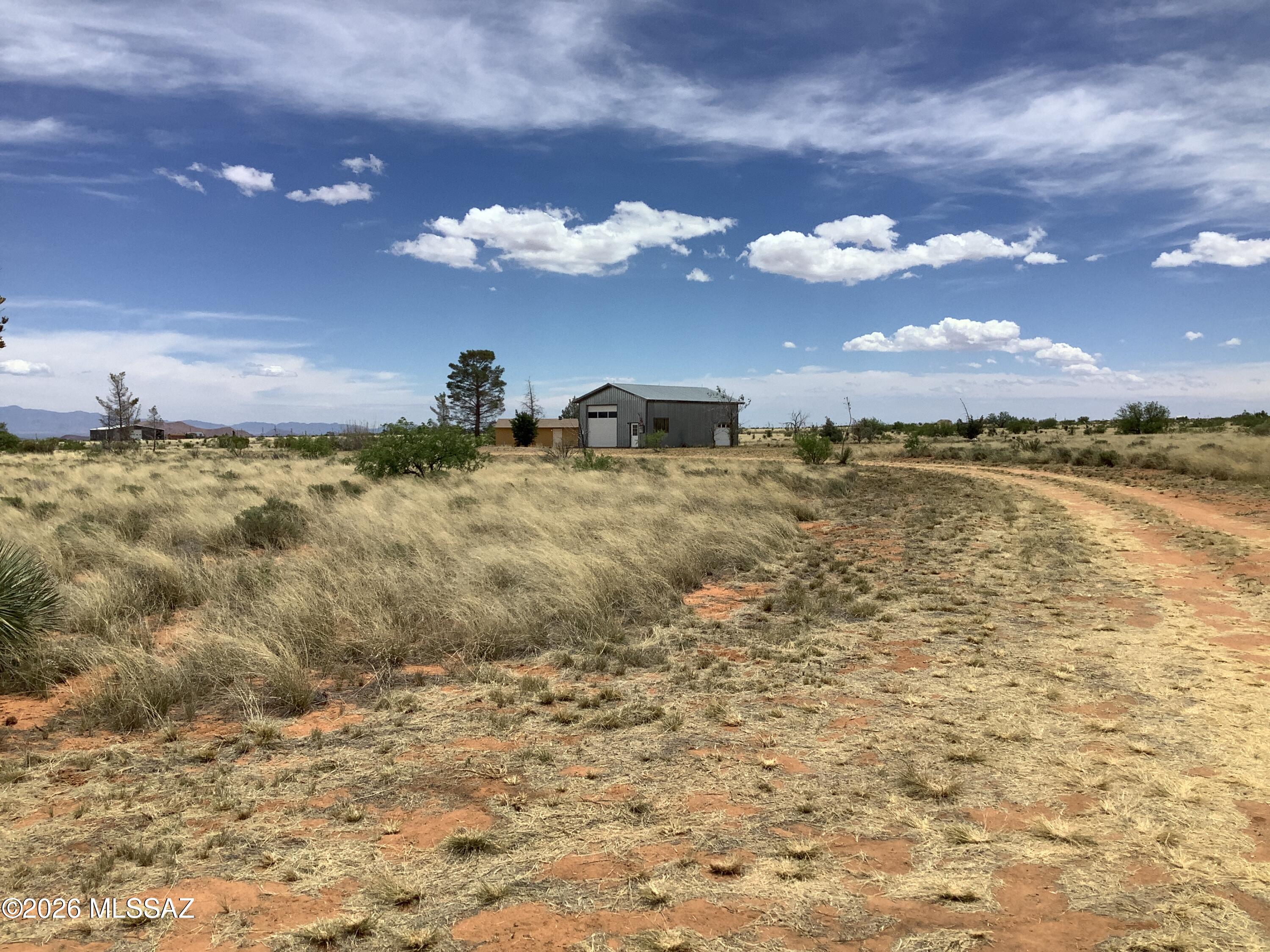 Not seen very often ... 40 acres in the heart of Sunsites/Pearce. This property offers a studio home with large eat-in kitchen, separate living room/bedroom combo & a full bathroom. The RV Garage has a full inside RV hook-up with plenty of space for additional indoor living that has built-in storage cabinets, an already existing kitchenette & full bathroom that consists of a separate shower room & a sink/toilet room. There is a standard garage door along with a large RV garage door. This unique property is scheduled for a new well & will be completed prior to close of escrow. The property also has two additional full uncovered RV hook ups, which makes this the perfect property to bring your friends/family & RVs to enjoy a break or make it your full-time home with just a few extra upgrades.