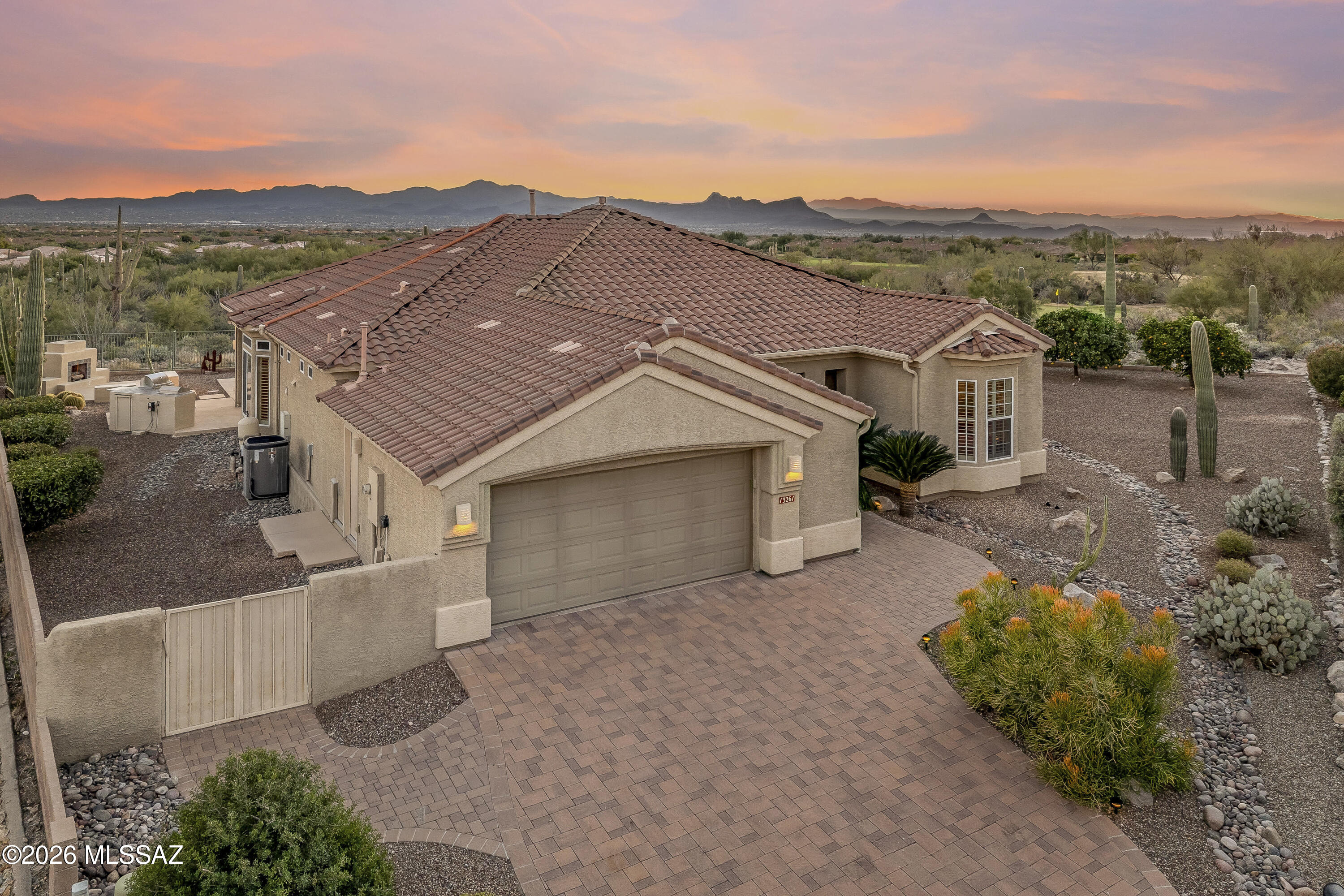 Truly a one of a kind JEWEL located in the gated Highlands at Dove Mountain. PRIVACY AND VIEWS are WOW WOW..... 180+ degree views of 5 mountain ranges, city lights, high Sonoran desert with abundance of saguaros, golf & so much more! Backyard entertaining areas include a pebble tec pool,  outdoor fireplace, outdoor kitchen w/new gas BBQ, electronic sun screens, built in gas heaters on patio, extensive decking and much more. This home is loaded with upgrades including a  custom kitchen island bar with slab granite countertop, built in hutch in great room, built in desk & book shelves in den-office, wood floors in great room & master suite, newly painted interior and exterior, paver driveway, walkways and so much more!  All furnishings are included.See documents for features & benefits list