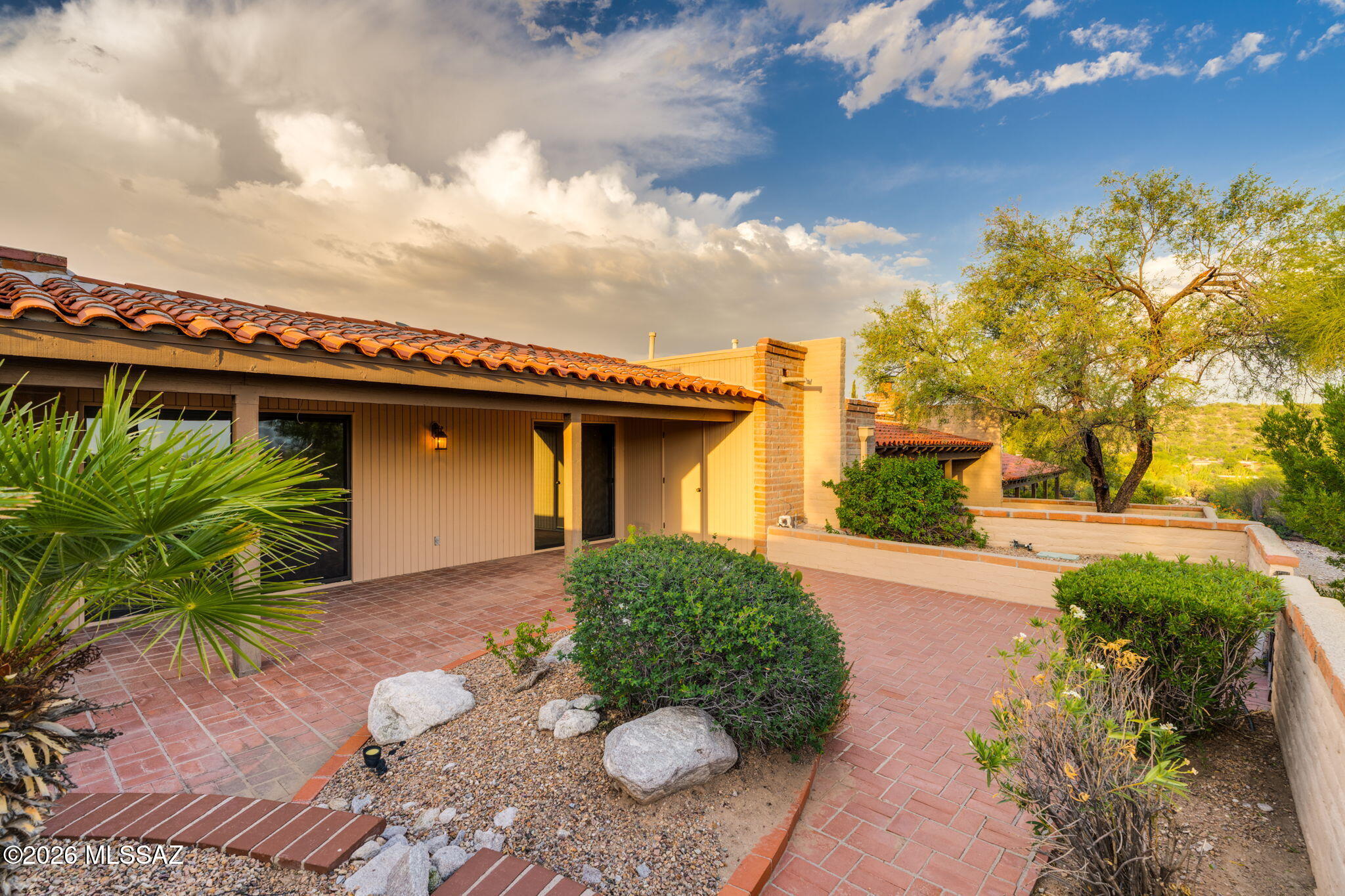 Beautiful city views, move-in ready, easy Catalina Foothills living come together in this lovingly maintained 2-bedroom, 2-bath townhome in the desirable Sunrise Ridge. Offering approximately 1,500 sq ft, this home has a comfortable, inviting feel and a desirable north-south orientation. Skylights throughout the home fill the interior with natural light, while the south-facing backyard and patio provide a wonderful place to unwind and enjoy Tucson's sparkling city lights and beautiful evening skies. From the open front yard, take in lovely mountain views and the surrounding desert landscape. The home has been thoughtfully cared for, with newly replaced fascia and recent exterior work adding to its well-maintained appeal. This community is especially appealing for its relatively flat, easy-to-walk setting, making it convenient to stroll to the community pool and tennis courts without navigating steep hills. Enjoy the relaxed pace of low-maintenance living while staying close to Catalina Foothills shopping, dining, hiking, golf, and everyday conveniences. A wonderful opportunity to enjoy the beauty of Tucson from a home that feels both comfortable and connected to its surroundings.     Don't miss this special home--come see all it has to offer!