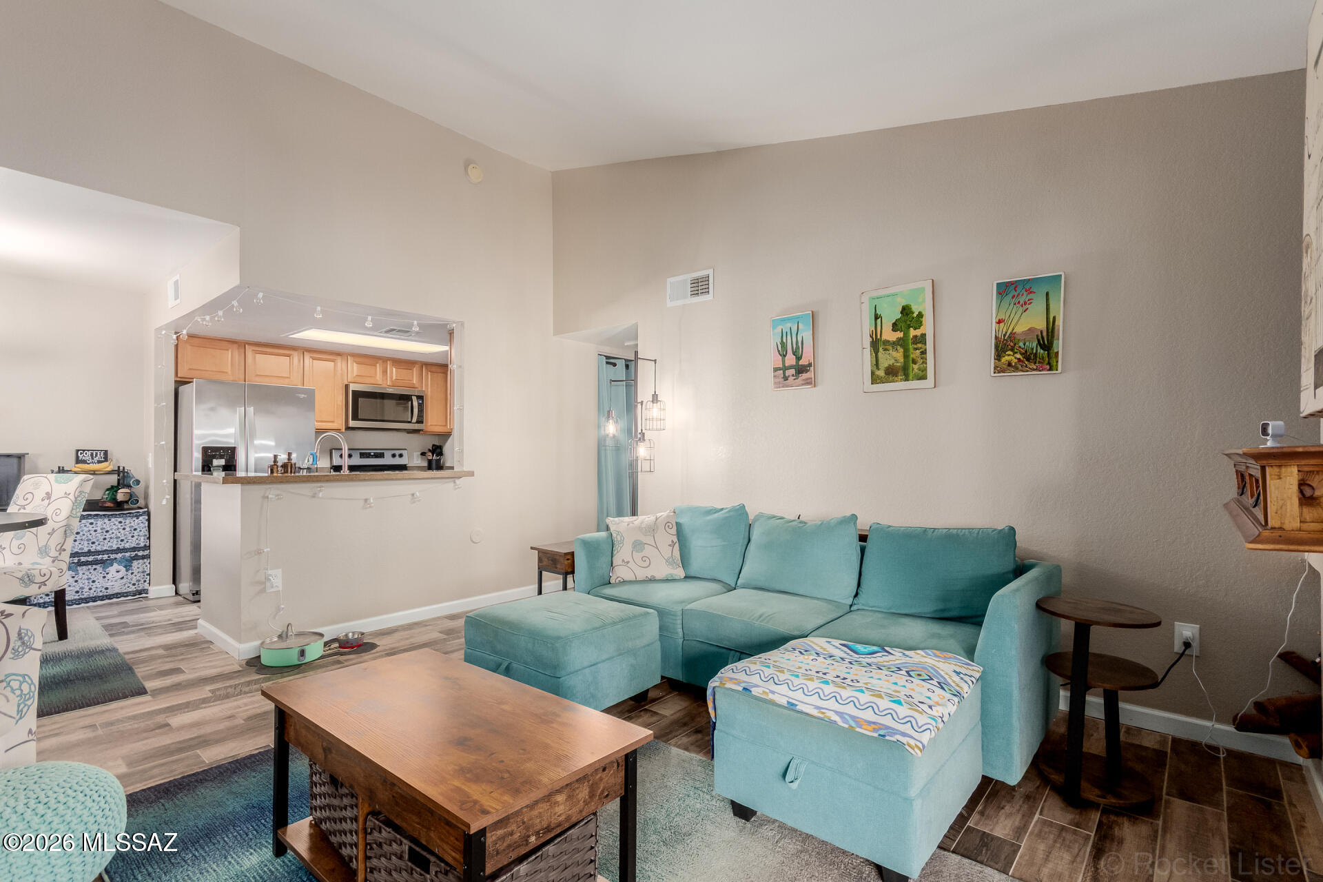 Beautifully updated home in the coveted Moonrise at Starr Pass condominium community! This inviting residence features a spacious 1,113 sq. ft. floor plan with 3 bedrooms, 2 bathrooms, and a bright, open living area designed for comfort and style. Rich plank flooring throughout and soaring vaulted ceilings create a modern, airy atmosphere filled with natural light. The lovely kitchen offers ample cabinet space, sleek stainless steel appliances, granite countertops, and a convenient breakfast bar that is perfect for casual dining or entertaining. Step outside to enjoy a private balcony, ideal for relaxing mornings or peaceful evenings, along with additional exterior storage for added convenience. Residents of Moonrise at Starr Pass enjoy wonderful community amenities including a sparkling pool and spa, fitness center, and tennis court.  In addition, passes are included with ownership, offering discounts at the Starr Pass for golfing, pro shop, and restaurants. The passes also include swimming at Marriot and Trune pools, and a discount at the Marriott restaurants. The location is exceptional, just minutes from the Richard Genser Starr Pass Trailhead, the luxurious JW Marriott Starr Pass Resort & Spa, world class golf, shopping, dining, and endless outdoor recreation. This is an incredible opportunity to enjoy the best of the Starr Pass lifestyle!