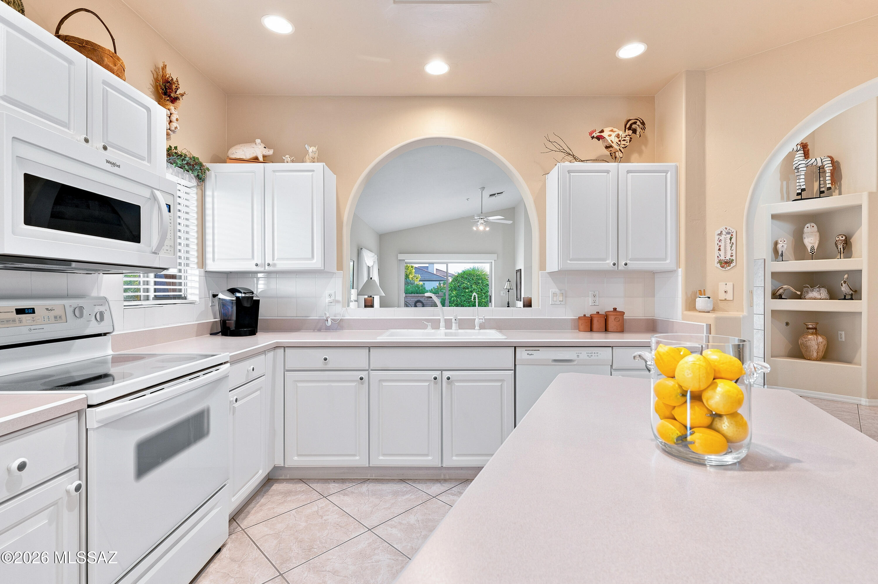 Some homes are measured in square footage. Others are measured in moments.

This charming 2-bedroom, 2-bath home in The Greens invites you to slow down and enjoy the best of Green Valley living. The open great room floor plan features graceful arched pass-throughs, a spacious kitchen with white appliances and a center island, and a private patio overlooking mature greenery. The primary suite includes an adjoining den or office and a walk-in shower with accessibility in mind. An insulated two-car garage and select furnishings available to convey complete this peaceful desert retreat.