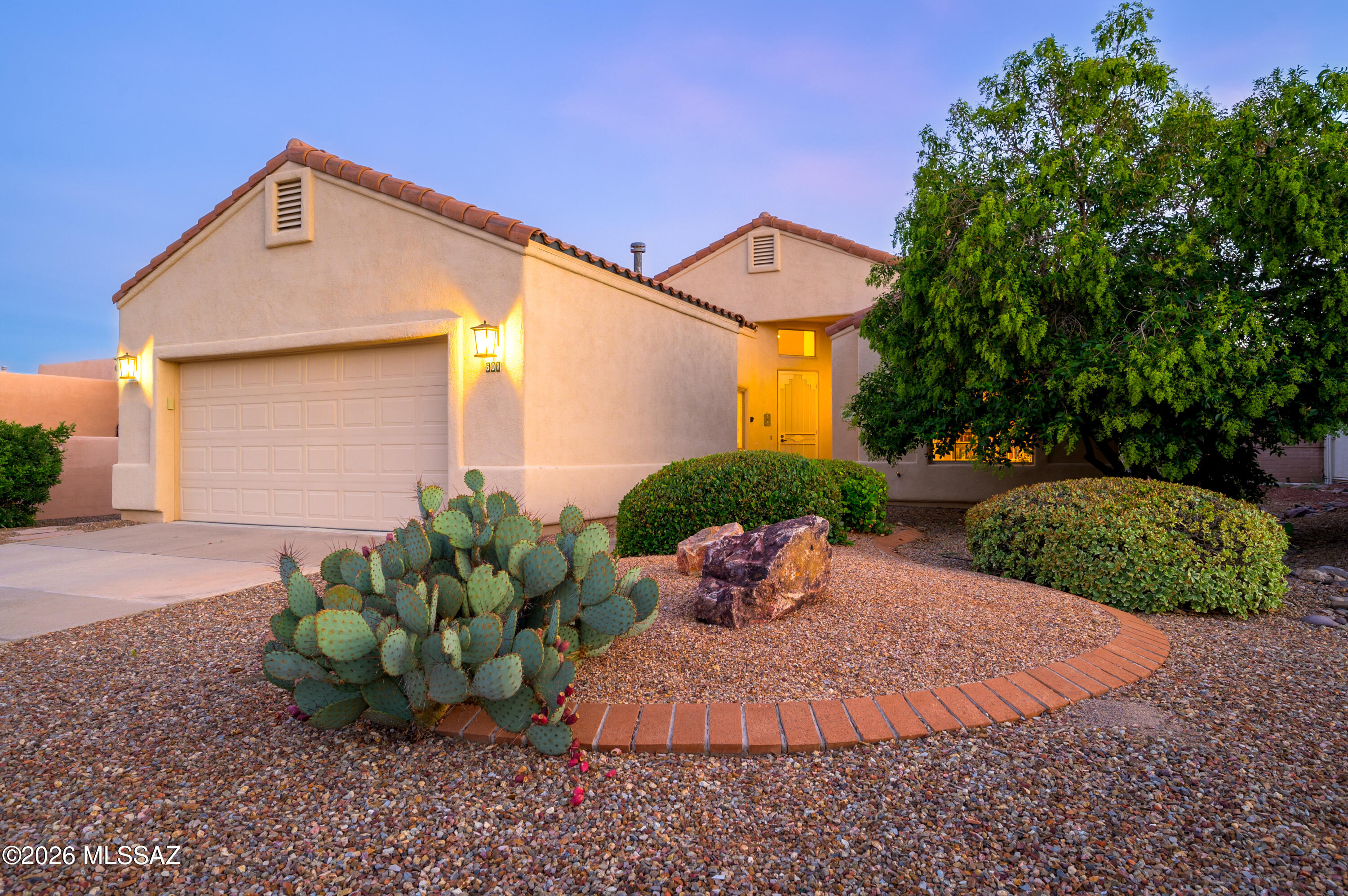 Some homes are measured in square footage. Others are measured in moments.

This charming 2-bedroom, 2-bath home in The Greens invites you to slow down and enjoy the best of Green Valley living. The open great room floor plan features graceful arched pass-throughs, a spacious kitchen with white appliances and a center island, and a private patio overlooking mature greenery. The primary suite includes an adjoining den or office and a walk-in shower with accessibility in mind. An insulated two-car garage and select furnishings available to convey complete this peaceful desert retreat.