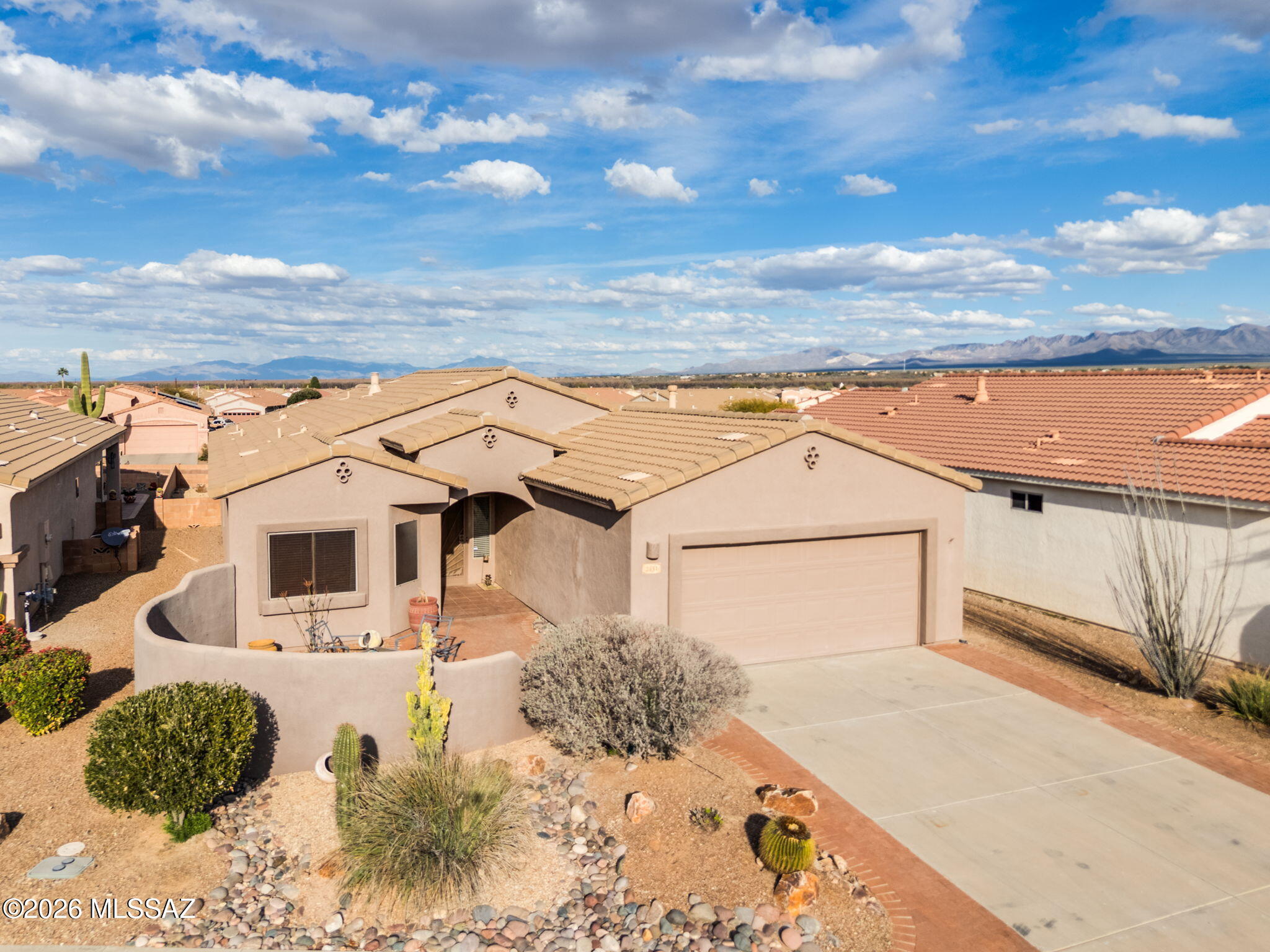 This appealing 3-bedroom, 2-bathroom, Den,  traditional home is a remarkable find in the The Legends development, within the Green Valley, AZ 55 + Active Community area. Enjoy inspiring views of Santa Ritas and Madera Canyon. The patio is perfect for grilling. The spacious, low-maintenance, and attractively landscaped yard sits on a pleasant street. An enclosed front porch and open-air back porch extend your living space. Step from the Welcome mat into an interior embrace that includes a stately entryway, an open layout, stylish fixtures, plentiful natural light, and a fireplace. The ample peninsula kitchen brims with granite countertops. Restful main-floor primary bedroom. The Sought after Holiday Floor Plan is ready to reflect your good taste in decor. Extended  2-car garage.