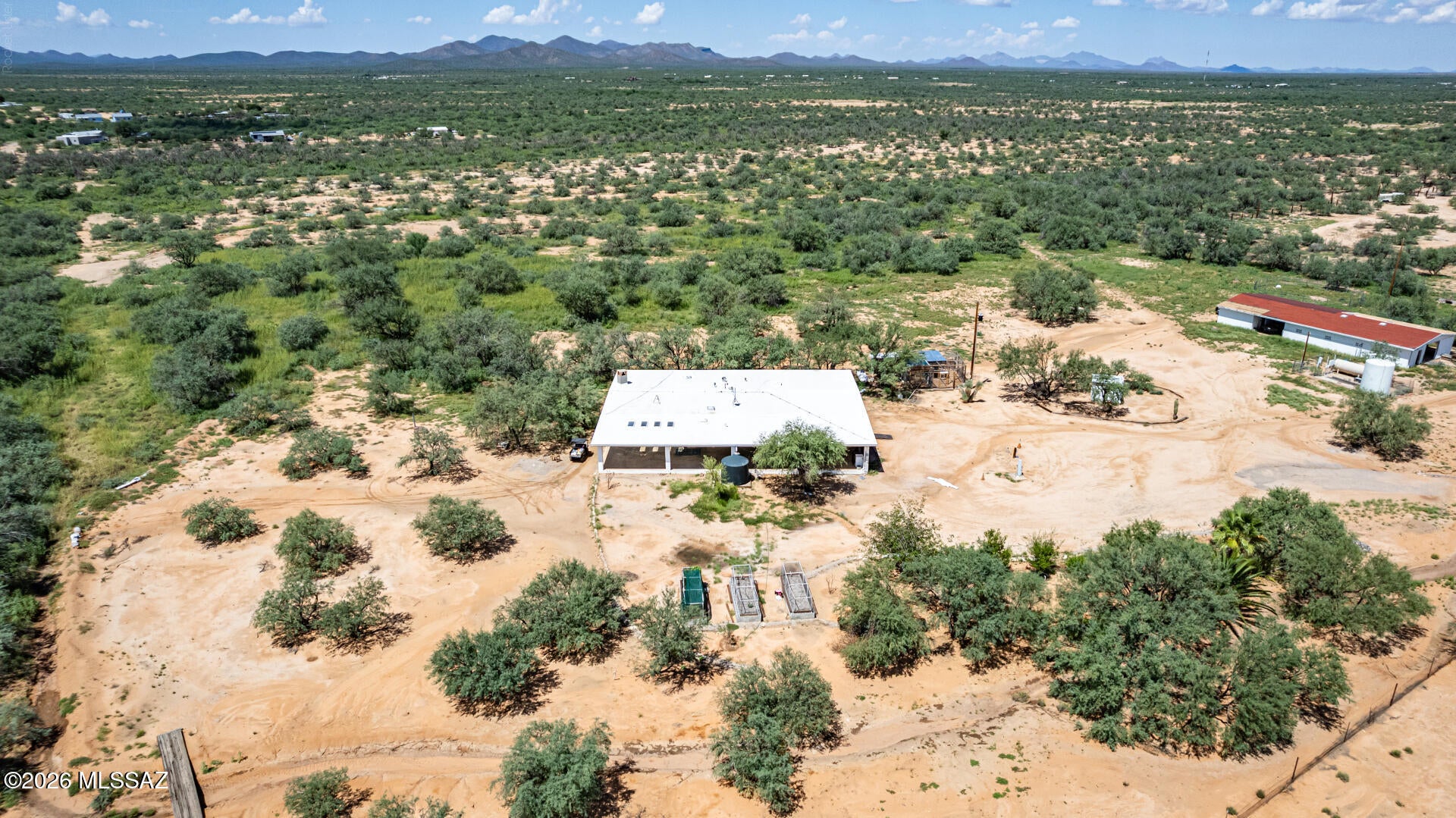 Priced to sell. This 3068 sq ft home plus 18 adjacent acres-Parcel 209-19-009F is ready for you to move right in. It has 4 bedrooms, 3 baths, family room, an additional bonus room/study/game room with access to the deck. There are 3 above ground gardens. Water harvesting in place. Chicken coops ready to go. Shop area in the barn plus six horse stalls just steps away from the main house. The barn has a breezeway for storing the extra vehicles.  Horse corral and turn outs for your livestock. Space for everything you might have. Property is fenced and is the access for additional 18-acre parcel to the west of the home. Amazing views of the surrounding mountains, sunsets and sunrises.  Shared well on site. Shopping on Ajo Way and on Valencia.
