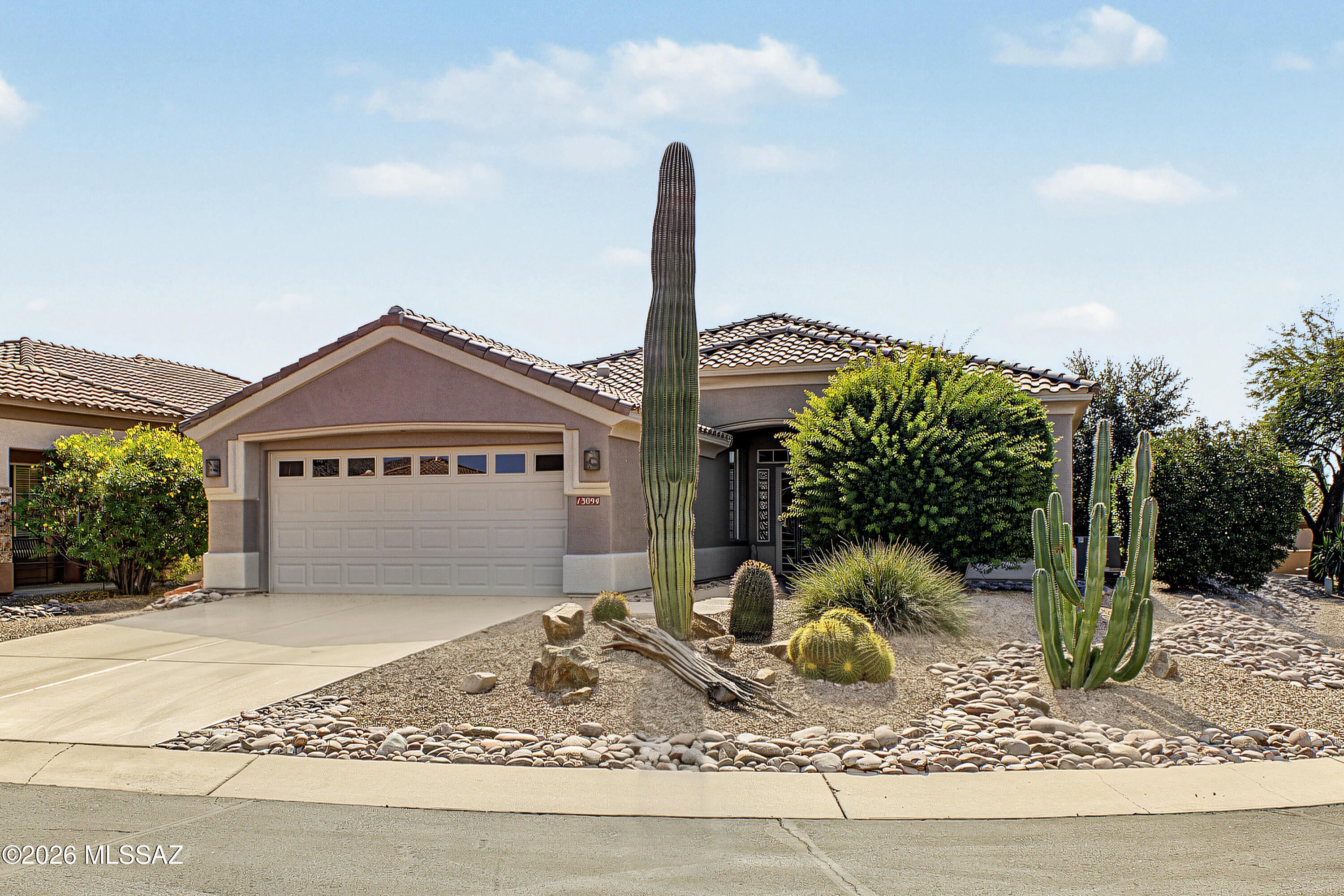 Welcome home to this beautifully updated, move-in-ready Hillsboro model perfectly positioned on an oversized corner lot. Enjoy dramatic Catalina Mountain views from your, elegant stamped concrete with a stone-finish look rear patio, framed by professional landscaping, a soothing water feature, and pull-down sunscreens. Inside, light-filled living spaces are enhanced by luxury vinyl plank flooring, plantation shutters throughout, and a bright solar tube in the den. The kitchen features granite countertops, distressed raised panel cabinetry, gas range, and a reverse osmosis system. Additional highlights include updated primary and guest bathrooms, newer water heater, roof and HVAC.  The detailed garage offers epoxy flooring, utility sink, water softener and wall-to-wall storage cabinets, matching the custom epoxy front entry walkway. This home offers a seamless blend of luxury, comfort, and top-tier community amenities. Enjoy world-class resort living with 24 hour manned-gated security, award winning golf course, tennis, pickleball, fitness center, pool, restaurant, bar and an incredible activities calendar and so much more!.