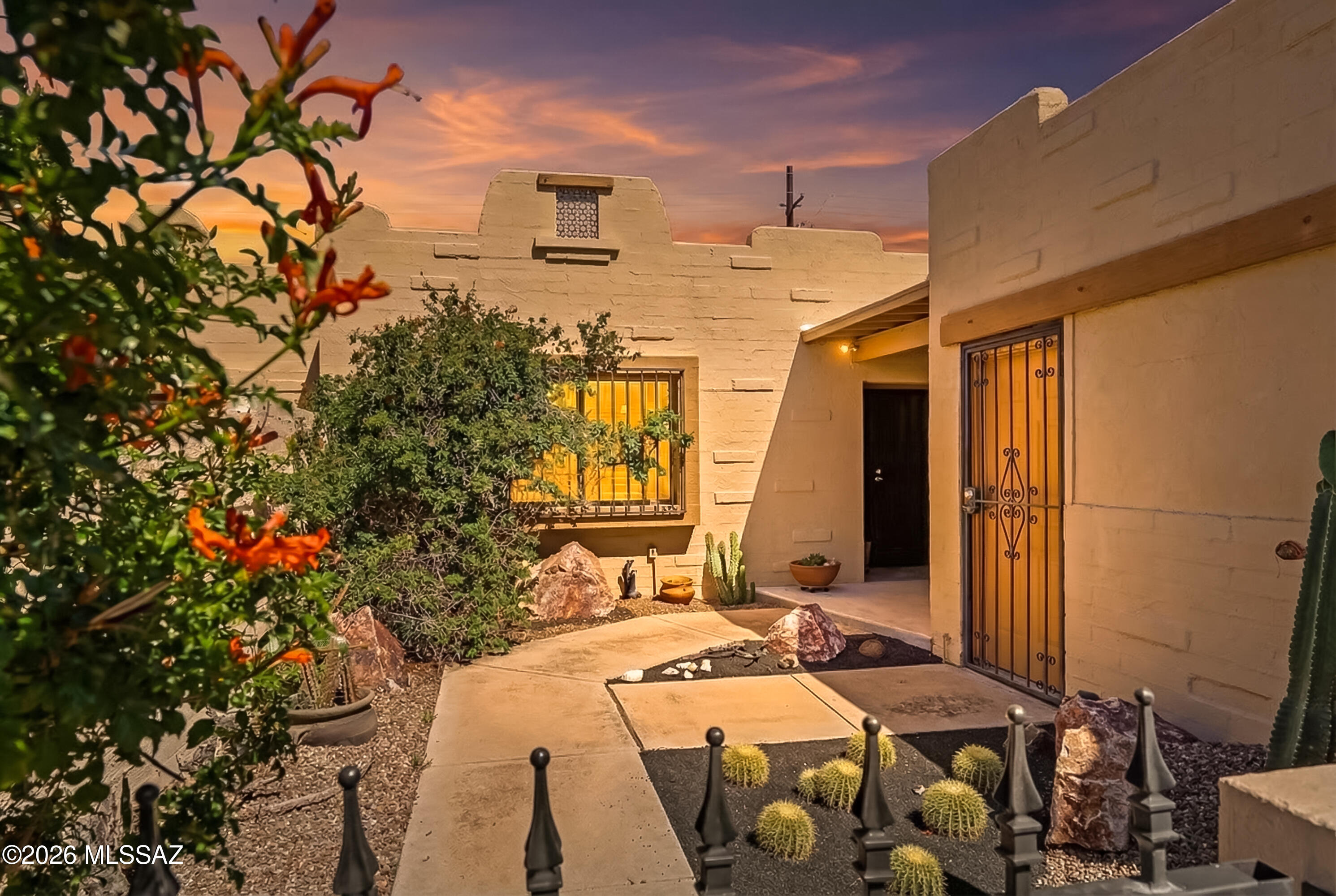 Tucked within the welcoming Moondance patio home community, this thoughtfully maintained residence offers generously sized living spaces, mature desert landscaping, and a highly convenient northwest Tucson location.
Inside, the home features spacious rooms and a comfortable layout designed for both everyday living and relaxed entertaining. The kitchen is well appointed with granite countertops and a breakfast bar, opening to the main living area where a fireplace creates a warm focal point. A laundry room with additional pantry storage adds everyday practicality. This residence offers uncommonly sophisticated styling coupled with a serene northwest setting.
The primary suite serves as a private retreat, complete with direct access to the covered patio--an inviting spot to enjoy quiet mornings or unwind in the evening. Outdoors, mature desert landscaping enhances both the spacious yard and the welcoming entry courtyard, creating a peaceful setting that embraces the Sonoran landscape.
Residents of Moondance enjoy access to a community pool and spa, while the two-car garage provides convenience and additional storage. Ideally located less than a mile from grocery stores, restaurants, and everyday amenities at Thornydale and Cortaro, this home combines comfort, character, and easy northwest living.