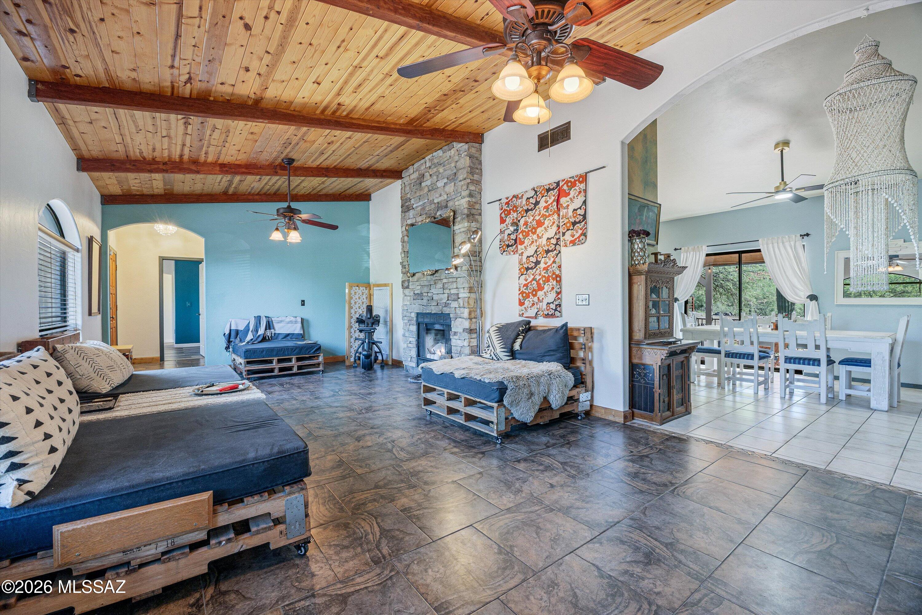 An opportunity to own this Southwest gem: 3 bed, 2 bath ranch style home complete with wood plank and wood beam ceilings, horse paddock, RV hookup, and breathtaking mountain views and sunsets on an acre lot. 20 min drive to Raytheon and 9 min to Casino Del Sol. Close proximity (end of street) to Robles Pass Trail Park providing public hiking and mountain biking trails. Garage includes a mini-split, built-in storage, overhead storage, two workshop areas, two windows, and a sink. Great for a workshop, gym, or studio to work out of. Primary bed/bath has three separate closets for your large wardrobe! Prepare your meals on eye-catching quartz counters as you enjoy the views of the mountain through the windows! Transferable Phoenix Pest Control termite warranty.