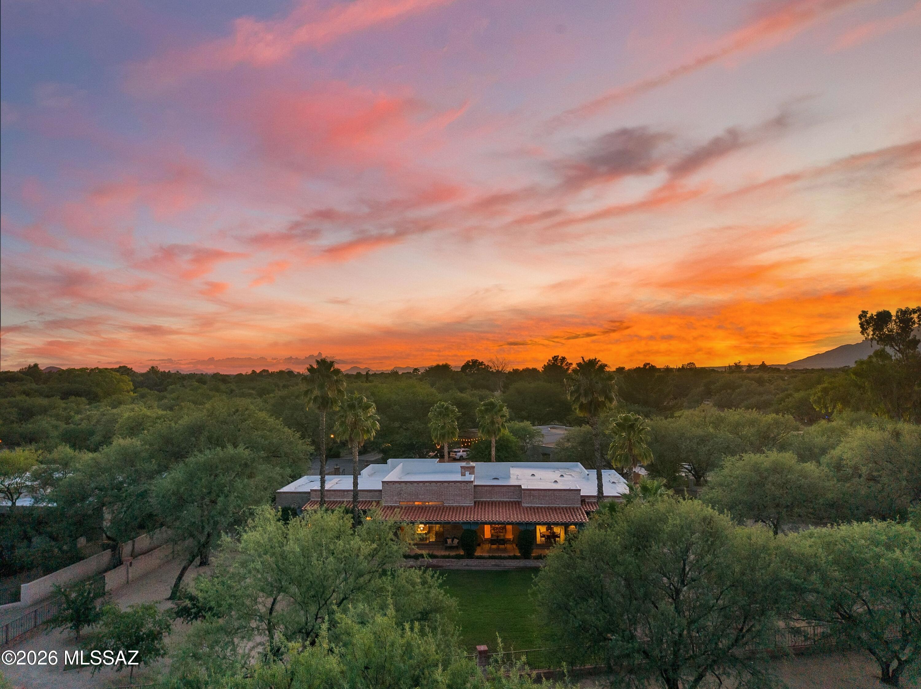 Exceptional custom masonry home, 3 bedrooms, 3 bathrooms, 3,887 sq ft on a private cul-de-sac lot backing the 5th fairway of Forty Niner Country Club. Mesquite lined driveway welcomes you to a courtyard entry with ornamental wrought iron. Inside, 13 ft wood plank-and-beam ceilings, Saltillo tile floors and a wall of windows with golf course views. Two-way fireplace warms the living and dining rooms. French doors open to a full-length wraparound covered patio and lush grass backyard. Ideal for relaxing and enjoying the view. Split floor plan with oversized primary suite, breakfast nook, laundry room and 2 car garage. Both HVAC units replaced 2023. Peaceful serene setting with the Catalina and Rincon Mountain views  as a backdrop. on a large .78  park-like lot. Meticulously maintained, this custom home blends quality craftsmanship, style and function in the coveted Forty Niner Country Club neighborhood. Forty Niner Country Club offers golf course living on Tucson's northeast side, with fitness center, heated pool, driving range, putting green and clubhouse and resturaunt. Close to Agua Caliente Park,  dining and shopping, Sabino Canyon and to Mount Lemmon.