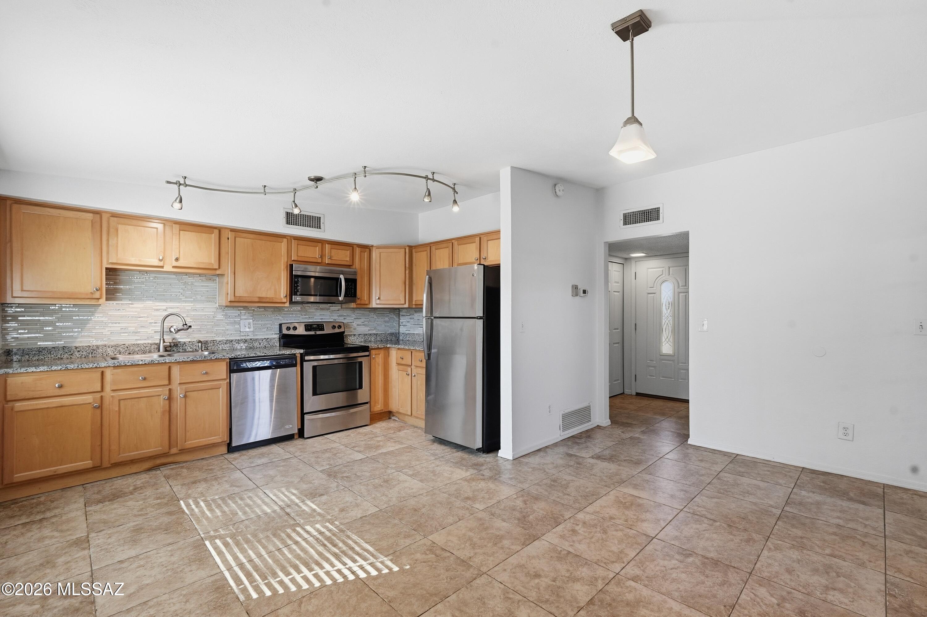UPDATED + MOVE-IN READY IN NW TUCSON! This 3BD/2BA home packs BIG value into 1,151 SF with fresh interior paint, NO CARPET, tile flooring throughout, newer windows & an updated kitchen featuring GRANITE countertops and stainless steel appliances. The functional floor plan makes excellent use of every inch, while leased SOLAR adds an energy-conscious bonus for Arizona living. Outside, the low-maintenance backyard offers plenty of room to entertain, garden, play or create your own desert retreat. Conveniently located near shopping, dining, parks, schools & I-10. Updated, affordable & ready for its next owner - come see why 6916 N Galaxy Place should be your Home SWEET Home!