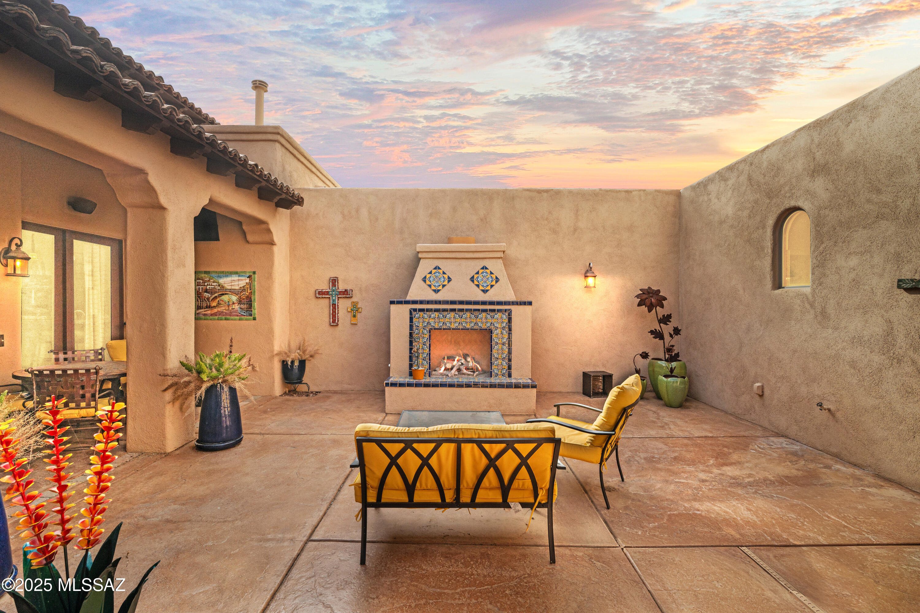 Exquisite gated Santa Barbara Ranch-style estate showcasing the pinnacle of Southwest elegance with unobstructed, panoramic views of the Santa Rita Mountains. Every detail of this home reflects thoughtful design, luxurious craftsmanship, and the seamless integration of indoor and outdoor living, offering a rare lifestyle of privacy, serenity, and refined entertaining.

Enter through a tranquil courtyard featuring a classic fountain and Southwest-tiled gas fireplace, connecting gracefully to the foyer, office/den, primary suite, and guest accommodations. The courtyard sets the tone for the home's signature indoor/outdoor flow, inviting natural light and sweeping mountain vistas throughout the main living spaces.

The gourmet kitchen is a chef's dream, featuring a Wolf six-burner gas stove, Sub-Zero refrigerator, expansive island with breakfast bar, and premium custom cabinetry. A wet bar with ice maker and wine cooler elevates entertaining, while a formal dining area adjacent to the kitchen and great room provides an elegant setting for intimate dinners or grand gatherings. The adjoining family/media room boasts state-of-the-art audiovisual systems, offering a cinematic experience for movie nights and sporting events.

A private courtyard casita offers luxurious guest accommodations with a Murphy bed, walk-in closet, full bath with tub and shower, and a dedicated mini-split system. The main residence also features an additional guest bedroom with ensuite bath and walk-in closet, and a spacious office/den with built-in desk, French doors, and direct courtyard accessperfect for work, study, or quiet retreat. Designer paint, 8-foot doors, plush carpeting in bedrooms and office/den, and plantation shutters throughout (solar screens in primary and den) highlight the home's exquisite finishes.

The primary suite is a private sanctuary with direct pool access, mountain views, and a spa-inspired bath featuring dual vanities, a makeup area, garden tub, walk-in shower, and separate water closet.

The resort-style backyard is a desert oasis designed for relaxation and entertaining. A chlorine pool has a brand new heater with electic controls and also has directly-plumbed solar heat, spa, putting green, and fully equipped outdoor kitchen with gas BBQ, bar seating, and new exterior refrigerator provide the ultimate setting for alfresco living. Architectural details include brick pavers, flagstone stepping stones, saguaro accents, and lemon, pink grapefruit, and orange trees, complemented by a walk-up balcony offering sweeping mountain and backyard views.

Additional highlights include security doors on all exterior entries, a 3-car garage with epoxy floors, cabinetry, high storage, workbench, and man door providing direct access to the backyard, and a laundry room with sink conveniently located off the garage entry. Advanced systems include EZ Water, Pentair REV reverse osmosis, and dual-zoned HVAC.

This rare gated estate masterfully blends luxurious finishes, thoughtful design, and resort-style outdoor living with breathtaking desert and mountain vistasa true Southwest masterpiece for those who demand elegance, privacy, and unparalleled comfort.

Every corner of this home is designed for comfort, elegance, and enjoymenttruly a place you will love coming home to every day.