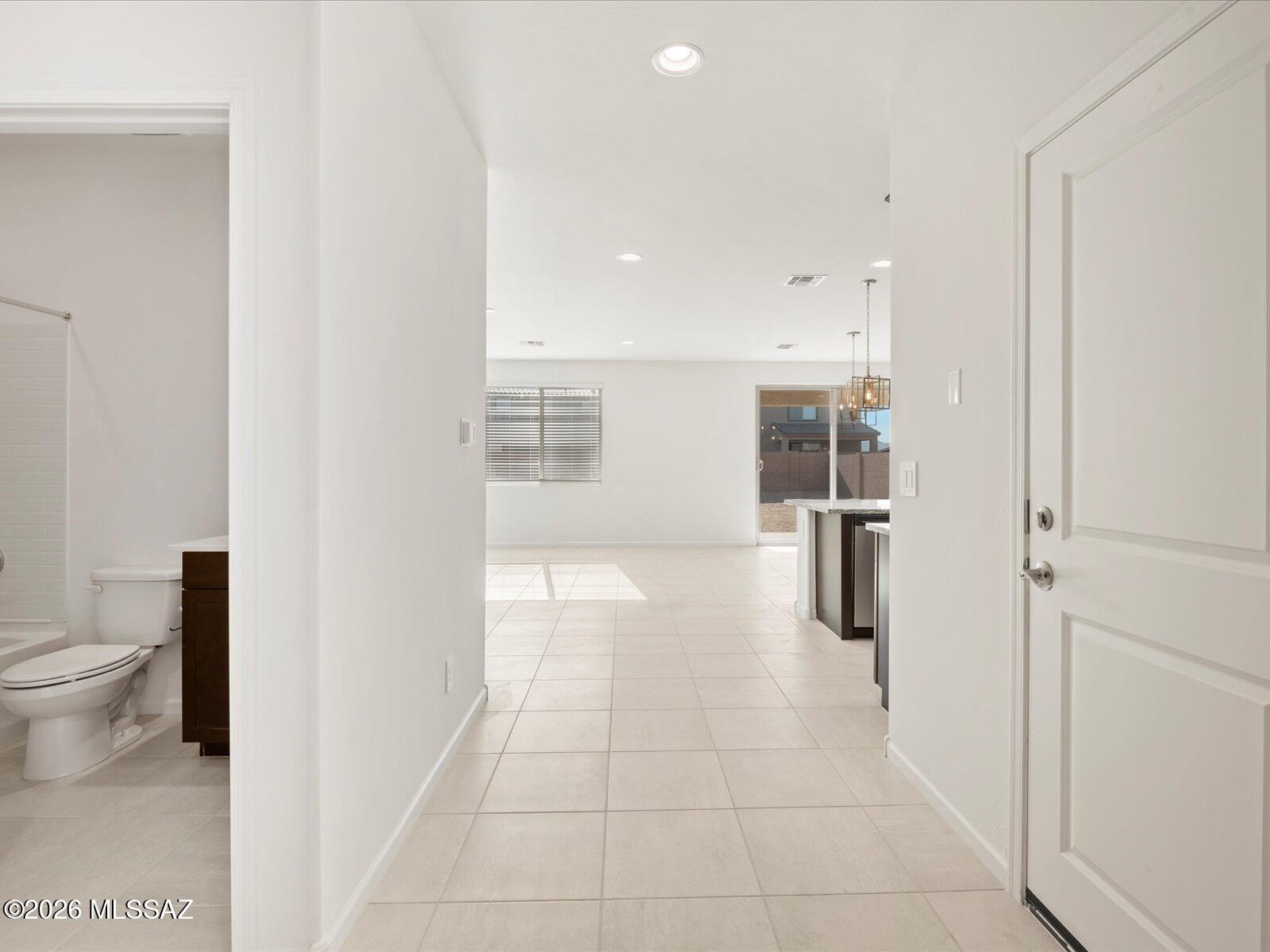 This generous 5-bedroom home includes a convenient downstairs guest suite with a full bath, ideal for visitors. Upstairs, a spacious loft offers additional living or entertainment space. Located in the new Mandarina community in Marana, AZ, residents will enjoy planned amenities like a pool, pickleball courts, parks, a dog park, and more. The home is move-in ready and includes a washer, dryer, refrigerator, and whole-home blinds. Built with advanced energy-efficient features, it's designed to provide comfort, savings, and peace of mind.