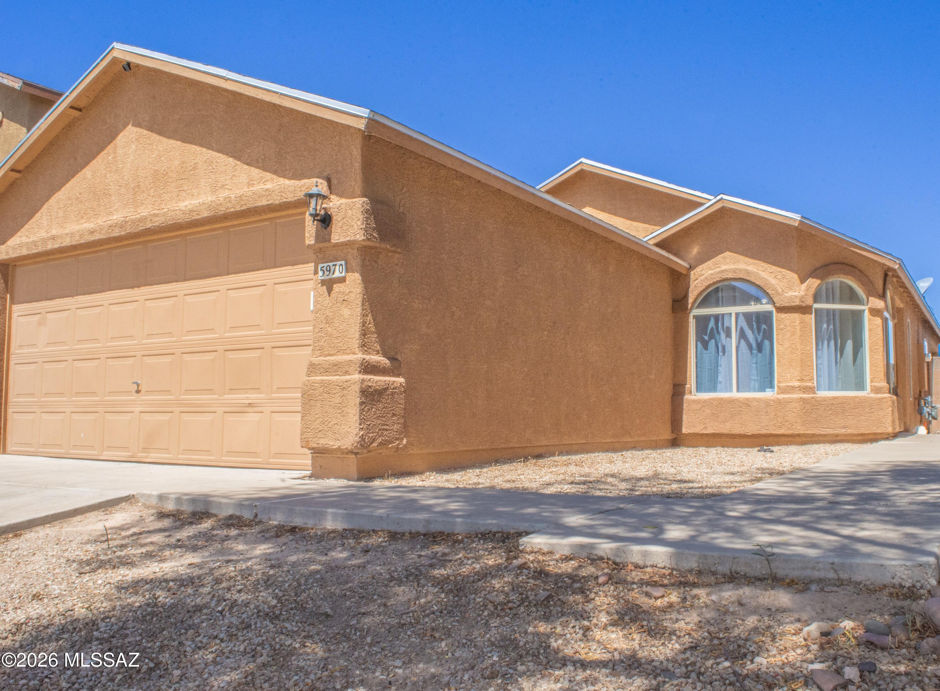 Welcome home to this charming 3-bedroom, 2-bath residence in the desirable Tres Pueblos community. Featuring a spacious 2-car garage, this well-maintained home offers durable tile flooring throughout, making upkeep a breeze. The inviting living room showcases vaulted ceilings that create an open, airy feel, while fresh interior paint adds a clean, modern touch. Enjoy morning coffee on the covered porch or entertain in the ample backyard with plenty of room to relax and play. Conveniently located and move-in ready, this home is a fantastic opportunity you won't want to miss!