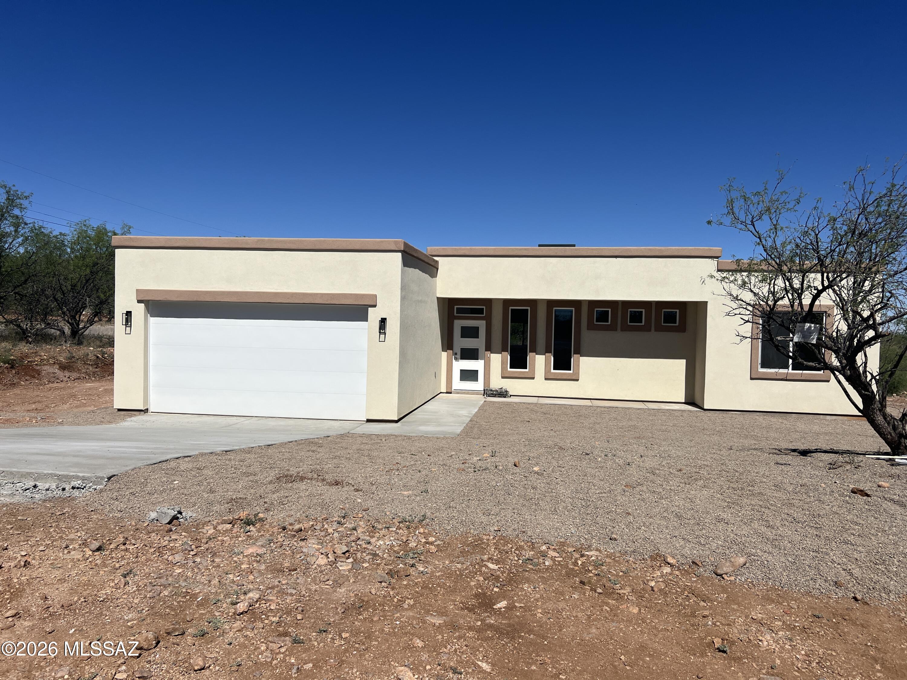 Corner lot, take a look to this NEW CONSTRUCTION house in Rio Rico enjoy the most beautiful mountains views from the covered patio and there is a very nice size front yard for a court yard to also enjoy the sunsets. It has 3 beds, 2 baths and 2 car garage. Ceramic tile throughout the house, great room open concept, spacious kitchen with quartz countertops and stainless steel appliances. Paved road close to the highway entrance and schools. Primary bedroom with walk-in closet. Call me for a private showing!!!