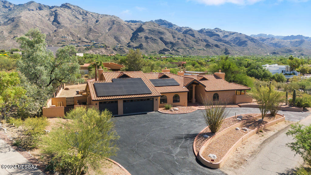 This beautiful property on almost an acre in the foothills has amazing mountain views from outside several windows and it feels like the mountains are right behind the pool and hot tub. Plus there is an outdoor kitchen & fire pit area with seating.  Close to Ventana canyon, shopping and golf course. 
Master bath has an amazing soaking tub with privacy and cactus views.
 Brand New owned Solar system installed(2024) with no loan!!
New granite counters, new appliances, and more. Circular driveway with 3 car garage and cabinets( yes, it can actually fit 3 cars). 2 AC units, one replaced June 2024. HOA covers a security guard that drives around and trash service.