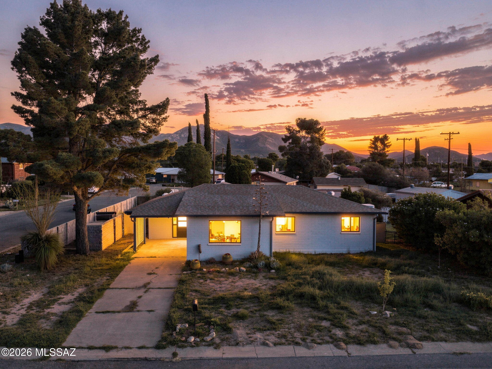 Discover the character and versatility of this 2-bedroom, 2-bath Bisbee home offering 1,072 sq. ft. of living space. The home features a welcoming living area, kitchen with adjacent dining space, and a spacious primary bedroom. The property also includes a separate workshop, providing flexible space for hobbies, projects, or additional storage. Enjoy mountain views, a fenced yard, charming patio, mature landscaping, and workshop/storage areas. No HOA!