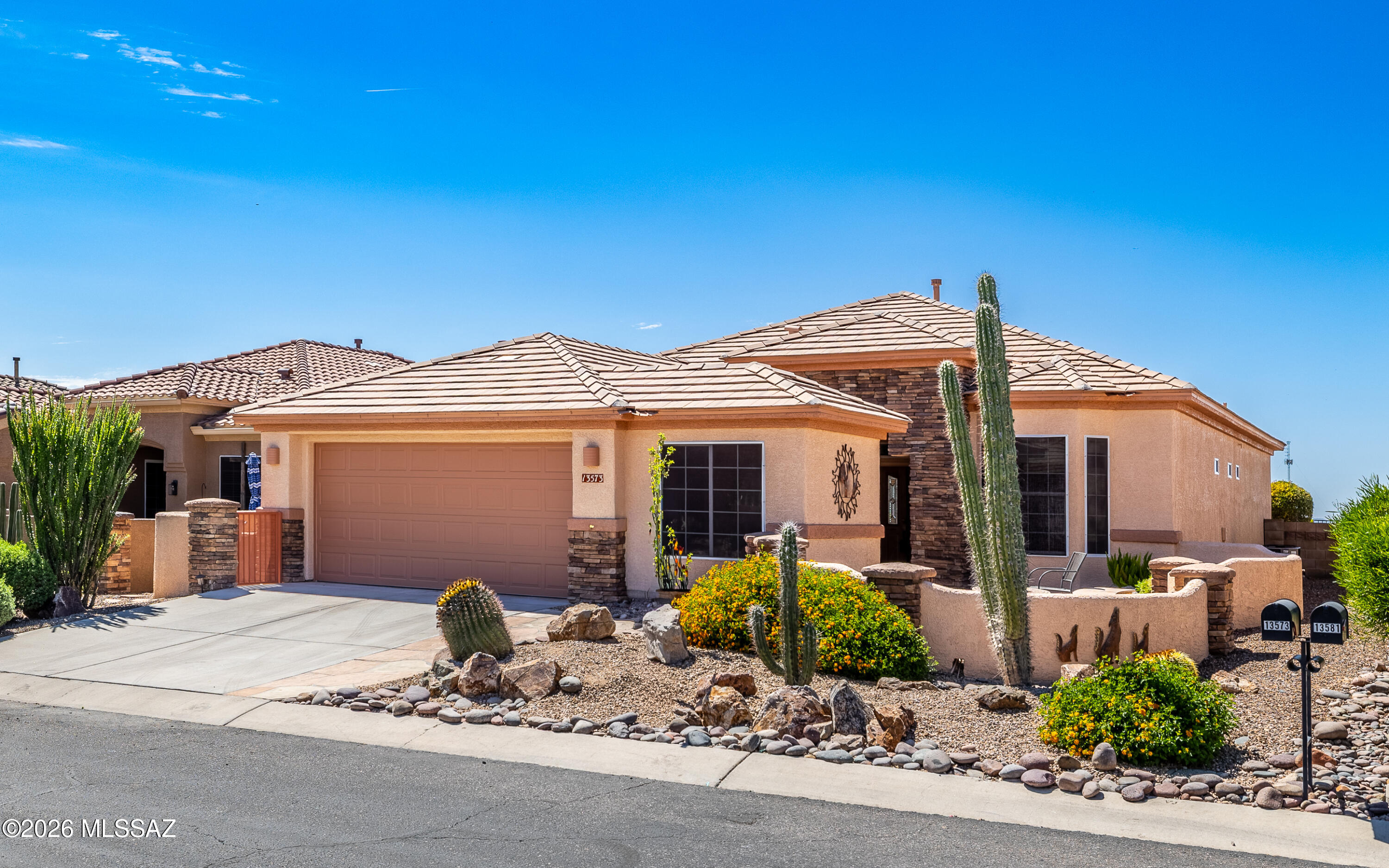 Ideal location - this lovely Hillsboro with 3 bay windows has one of the best Marana city light viewing backyard. Backs to nature - city lights to the south - mountains to the NW - just an overall tranquil and peaceful location. Brand new installed quartz kitchen countertops and backsplash- fresh, clean and bright. Master bathroom nicely updated with stylish shower.  Two lovely water features - on located in the spacious gated front courtyard and the other against the rear view fencing of the backyard. Both water features just services and are sparkling clean.  Lovely mountain views from gated front courtyard - even better city lights, mountain, sunset and  nature views from the extended backyard. Come view this most popular Hillsboro model w/all three bay windows.  And NO carpet!