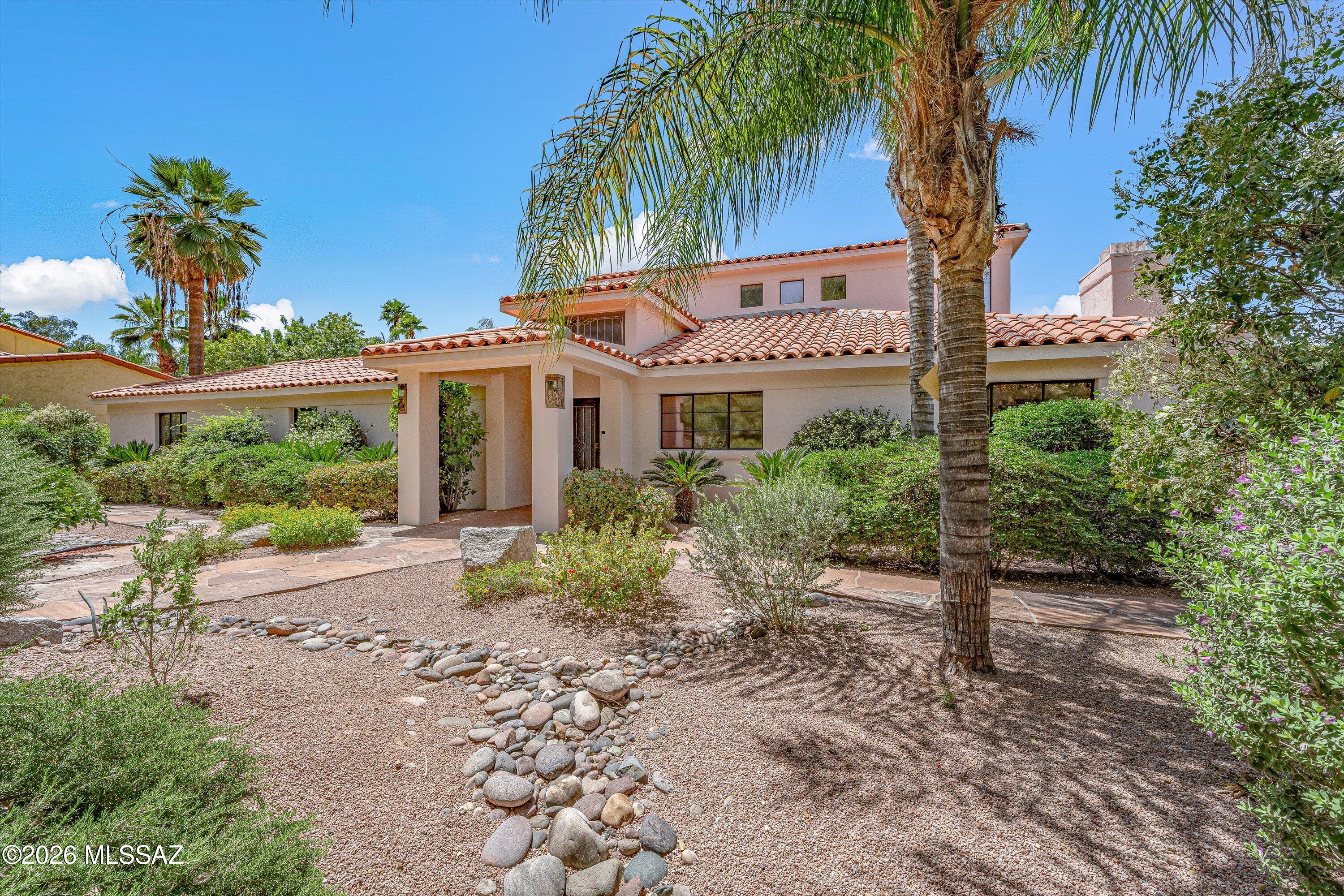 Situated within the distinguished neighborhood of Tucson's historic El Encanto Estates, this exceptional luxury residence offers a rare combination of privacy, heritage, and refined living. The impeccably renovated kitchen boasts bespoke finishes, complemented by an elegant family room featuring a gracious indoor/outdoor bar. The grand primary suite serves as an exquisite retreat, complete with its own private balcony. The manicured grounds present a tranquil oasis featuring a stately fireplace ramada, private water well, and a magnificent saltwater pool and spa. Historic Designation, this premier central estate affords substantial property tax reductions for its next custodian.