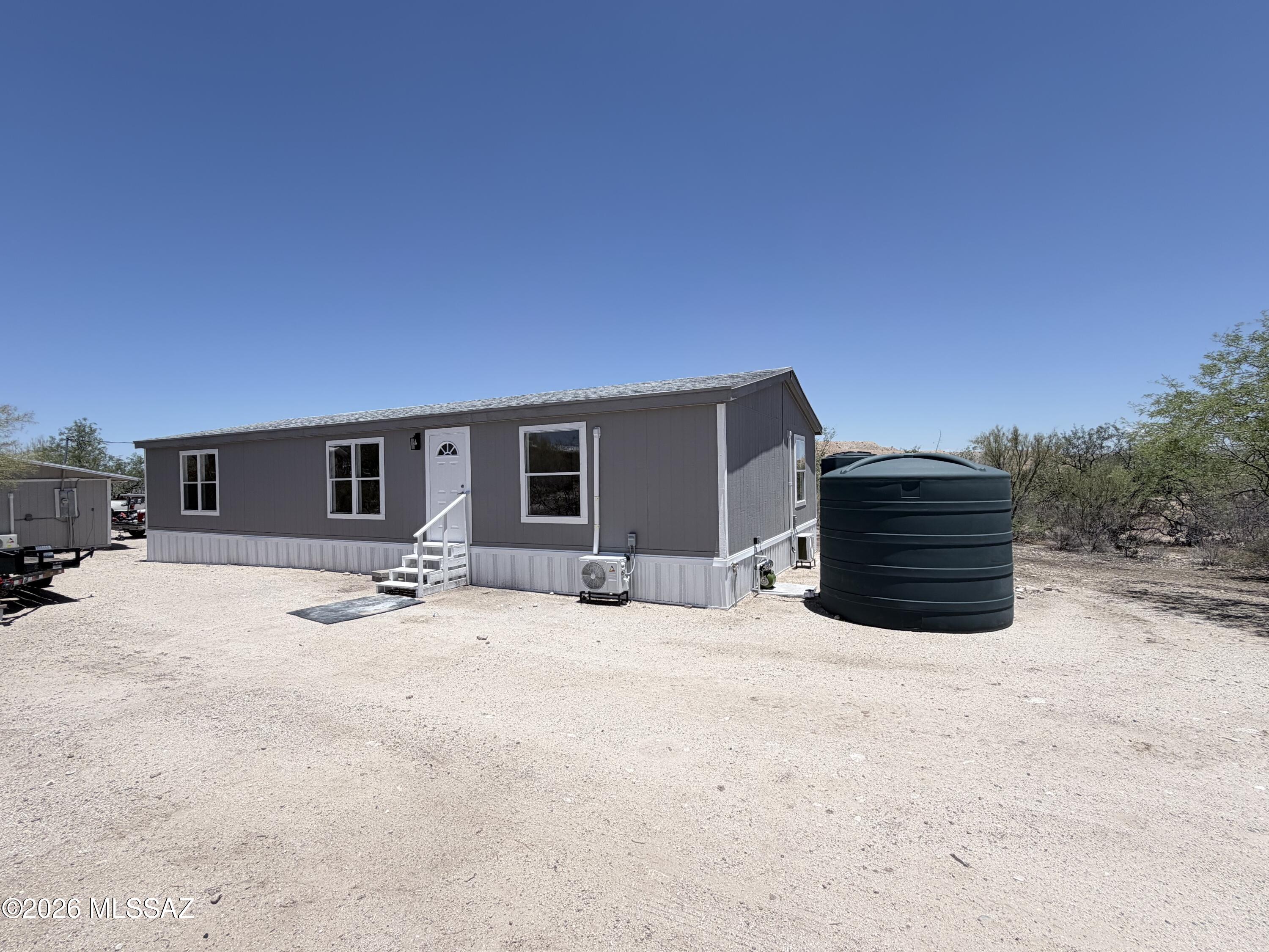 Recently updated 3-bedroom, 2-bath home situated on a spacious 1-acre lot! The main home offers modern updates and move-in-ready appeal with a comfortable, functional layout. The property also includes a detached, **unpermitted** 1-bedroom, 1-bath guest house featuring a kitchen and washer/dryer hookups, providing flexible bonus space for a variety of potential uses. Enjoy the privacy and possibilities that come with a full acre, offering plenty of room for outdoor living, parking, hobbies, or future improvements. Buyer to verify all facts, figures, measurements, and the status and permitted use of the guest house to their satisfaction.