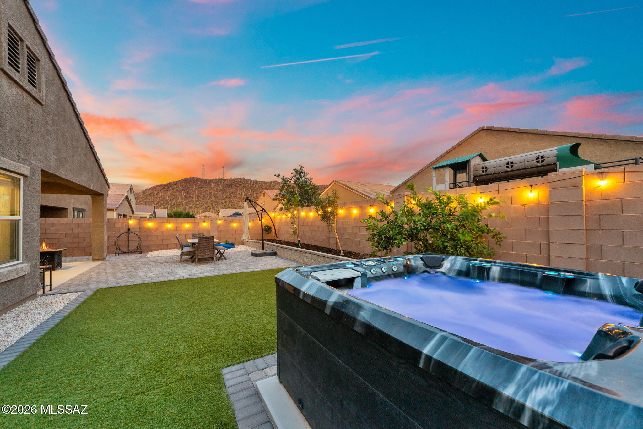 Stunning single-story home located in the sought-after Saguaro Bloom community featuring 4 bedrooms, 3 full baths, and a tandem 3-car garage. This spacious and functional floorplan includes a private en-suite bedroom, ideal for guests, multigenerational living, or a home office setup. Inside, you'll love the vaulted ceilings, open-concept layout, and no carpet throughout the home. Additional upgrades include reverse osmosis, a water softener, widened driveway with pavers, and thoughtful finishes throughout. Step into the backyard oasis and enjoy breathtaking mountain views while relaxing in your private hot tub -- the perfect place to unwind and enjoy Arizona sunsets.
Located in the vibrant Saguaro Bloom master-planned community offering resort-style amenities including a community pool, splash pad, parks, playgrounds, basketball courts, and miles of walking and biking trails woven throughout the neighborhood. Conveniently located near schools, shopping, dining, and I-10 access. Seller is licensed to sell Real Estate in the state of Arizona.