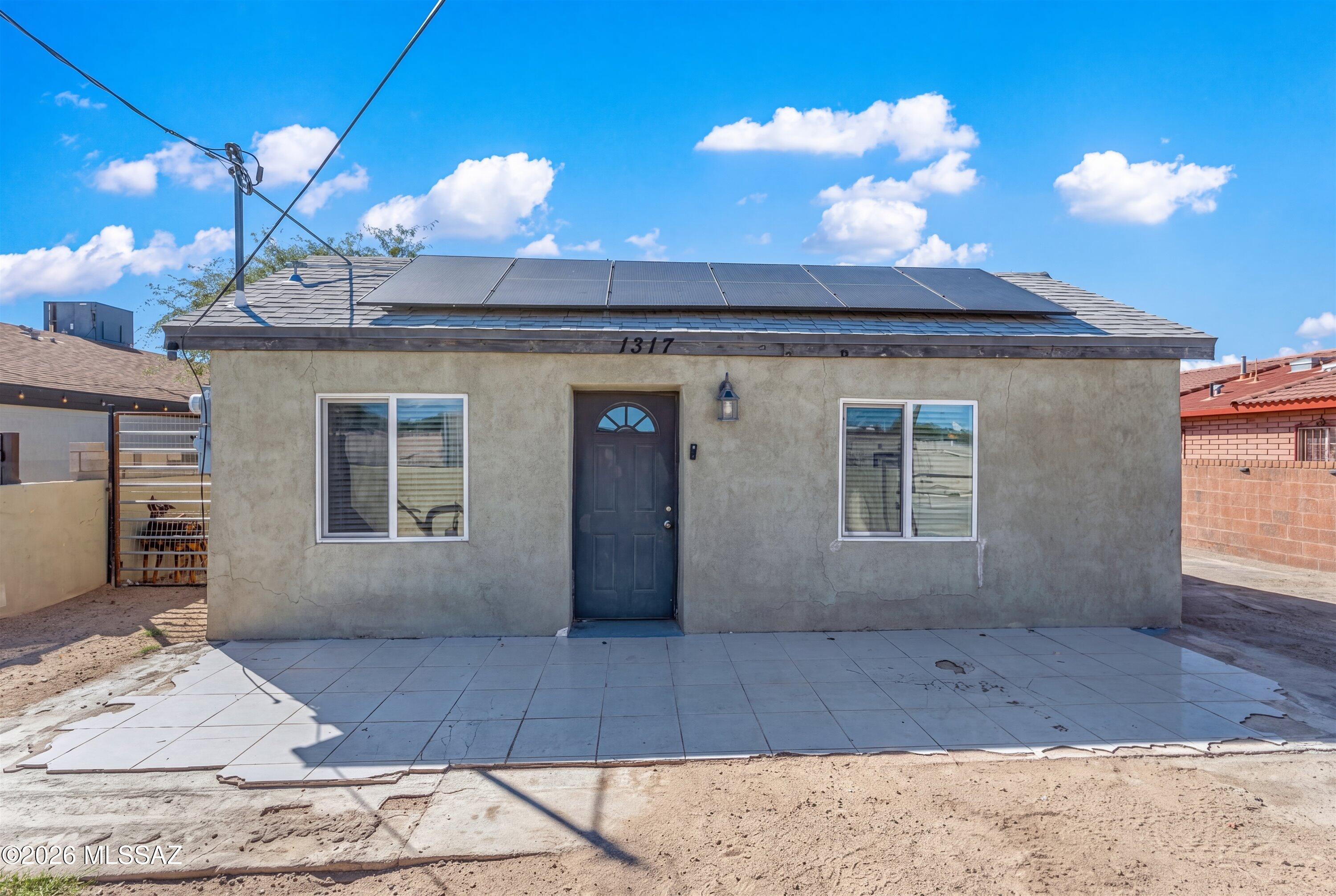 Welcome Home! This 3-bedroom, 2-bathroom, 1,219 sq. ft. home offers a convenient Central Tucson location with solar panels and double gates providing easy vehicle access onto the property.

Inside, enjoy a beautifully updated kitchen with striking white cabinets, stainless steel appliances, and granite-style countertops, complemented by wood-plank ceramic tile throughout the living areas. The bathrooms have been tastefully updated with attractive tile work and modern lighting and plumbing fixtures.

Outside, enjoy a fully gated property, spacious paved patio, and low-maintenance landscaping. Conveniently located near I-10, Downtown Tucson, shopping, dining, and entertainment.

A beautifully updated home with solar, great vehicle access, and a convenient Central Tucson location!