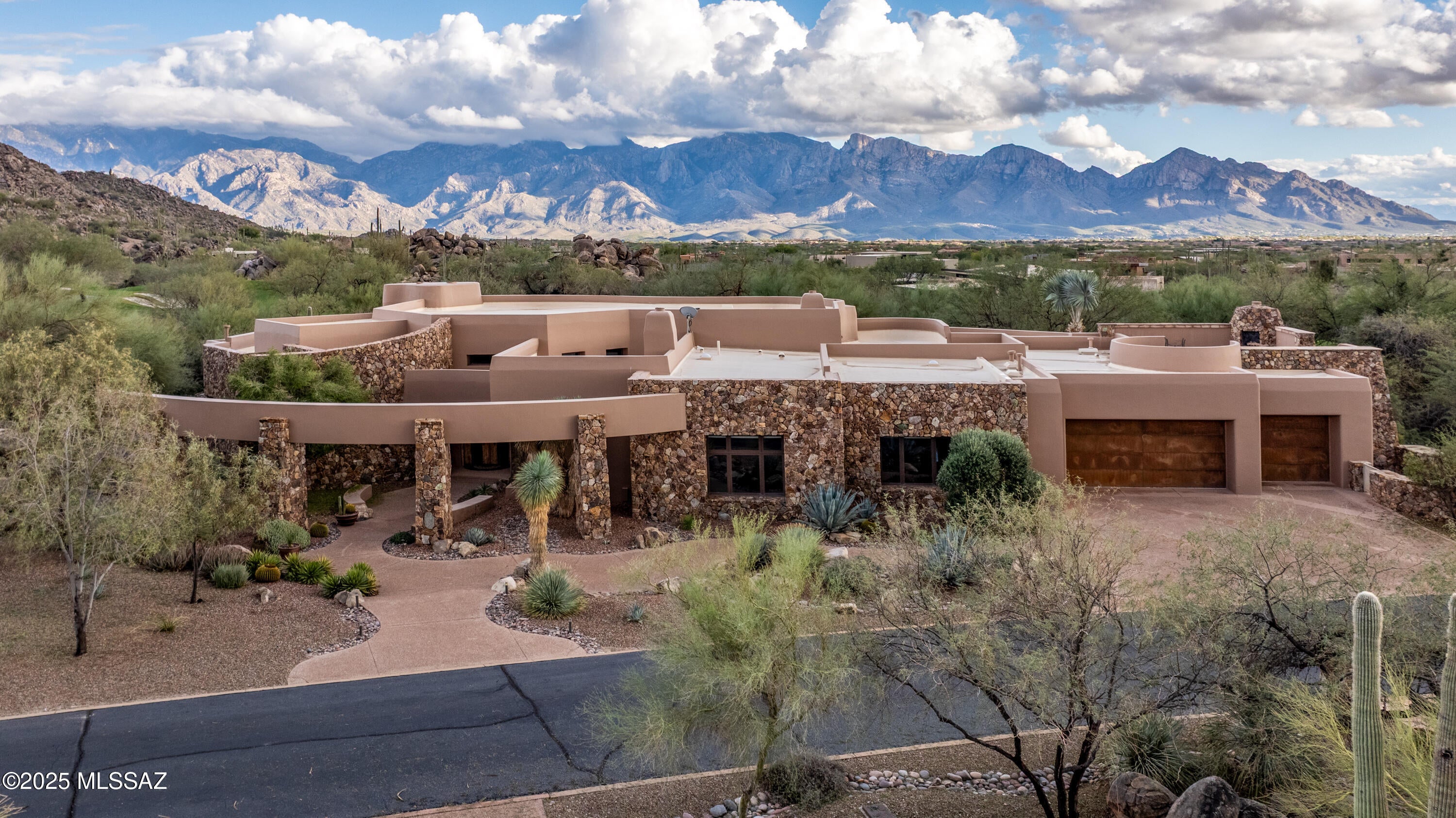 Rock-solid masonry construction meets timeless luxury in this impeccably crafted residence, perfectly positioned along the 17th fairway with sweeping Catalina Mountain and sunset views. Designed by acclaimed architect Ron Robinette with interiors by Lori Carroll, every detail reflects uncompromising quality and thoughtful design. This home offers a furnished designer interior, that seamlessly blends refined elegance with comfortable everyday living. Expansive living spaces are anchored by multiple fireplaces, high ceilings, and seamless indoor-outdoor flow. The split-bedroom layout provides privacy, while generous gathering areas are ideal for entertaining. Outdoor living is elevated with a pool, spa, and cascading water feature, lush citrus trees, a rooftop deck with fireplace capturing panoramic views of the golf course and surrounding mountains, and an outdoor built-in BBQ area perfect for alfresco dining.

Set within the guard-gated Stone Canyon community, this property delivers privacy, architectural integrity, and a truly exceptional desert lifestyle - An elevated retreat in every sense.