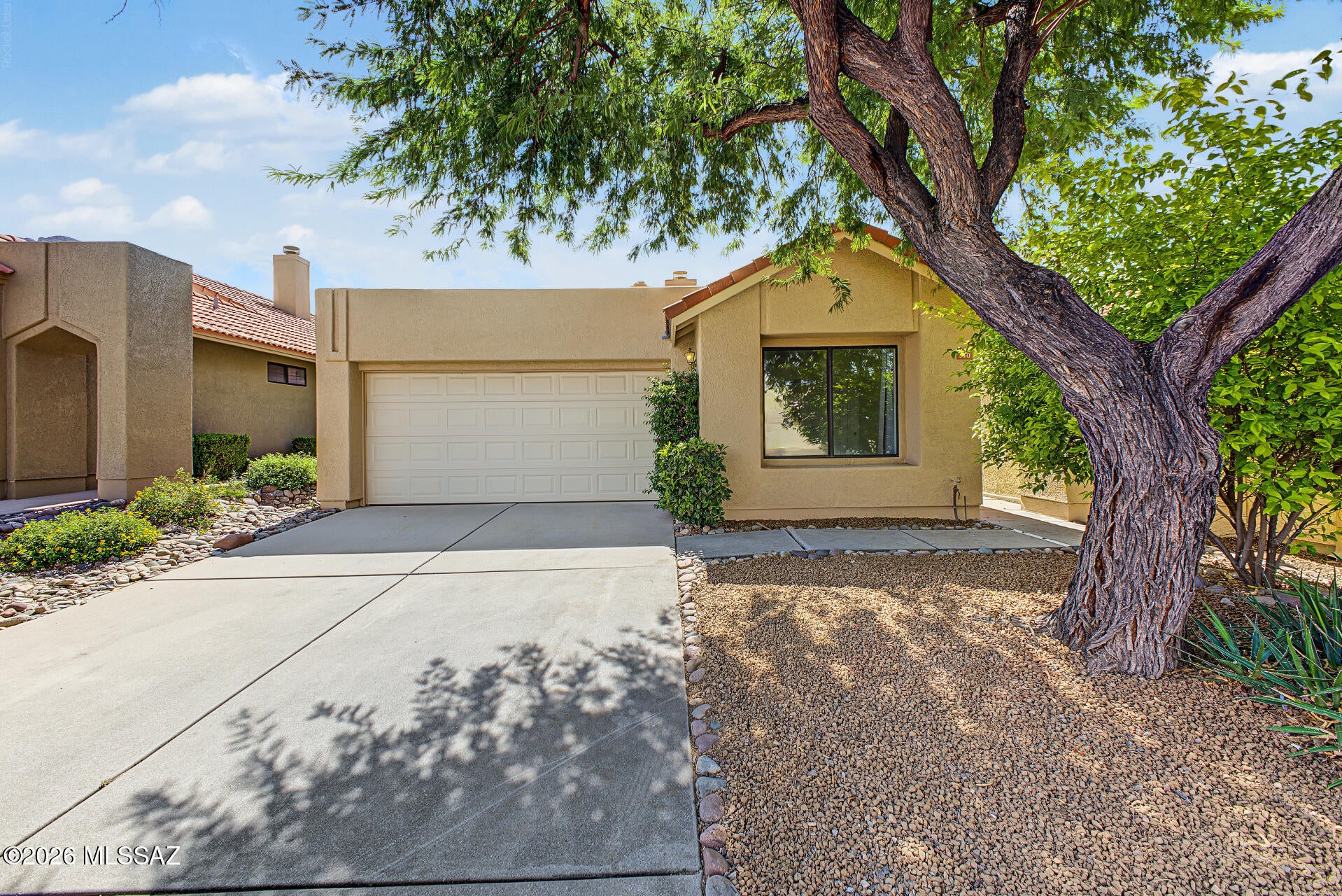 Beautifully remodeled patio home featuring a small private yard and sweet mountain views! This move-in-ready home offers a long list of thoughtful updates, including new modern ceramic tile, oversized baseboards, a  gorgeous new Corian countertop,  professionally painted kitchen and bathroom cabinets with new hardware, a new stainless-kitchen sink, SS appliances and updated faucets throughout. The Great Room showcases soaring ceilings, contemporary lighting, and new white light switches and covers for a fresh, modern look. Additional upgrades include a newer roof, new window coverings, a new ceiling fan in the primary bedroom, and a new living room wall light created. Step outside to enjoy the lovely backyard landscaping and private outdoor space. The front yard also features new gravel The HOA takes care of the front yards, common-area landscaping, trash, and the community heated pool, complete with cabana and restrooms.
Technically located in Oro Valley, this convenient location offers easy access to the rest of the Tucson area. With numerous updates already completed, this home is truly move-in ready--and there are even more upgrades to discover!