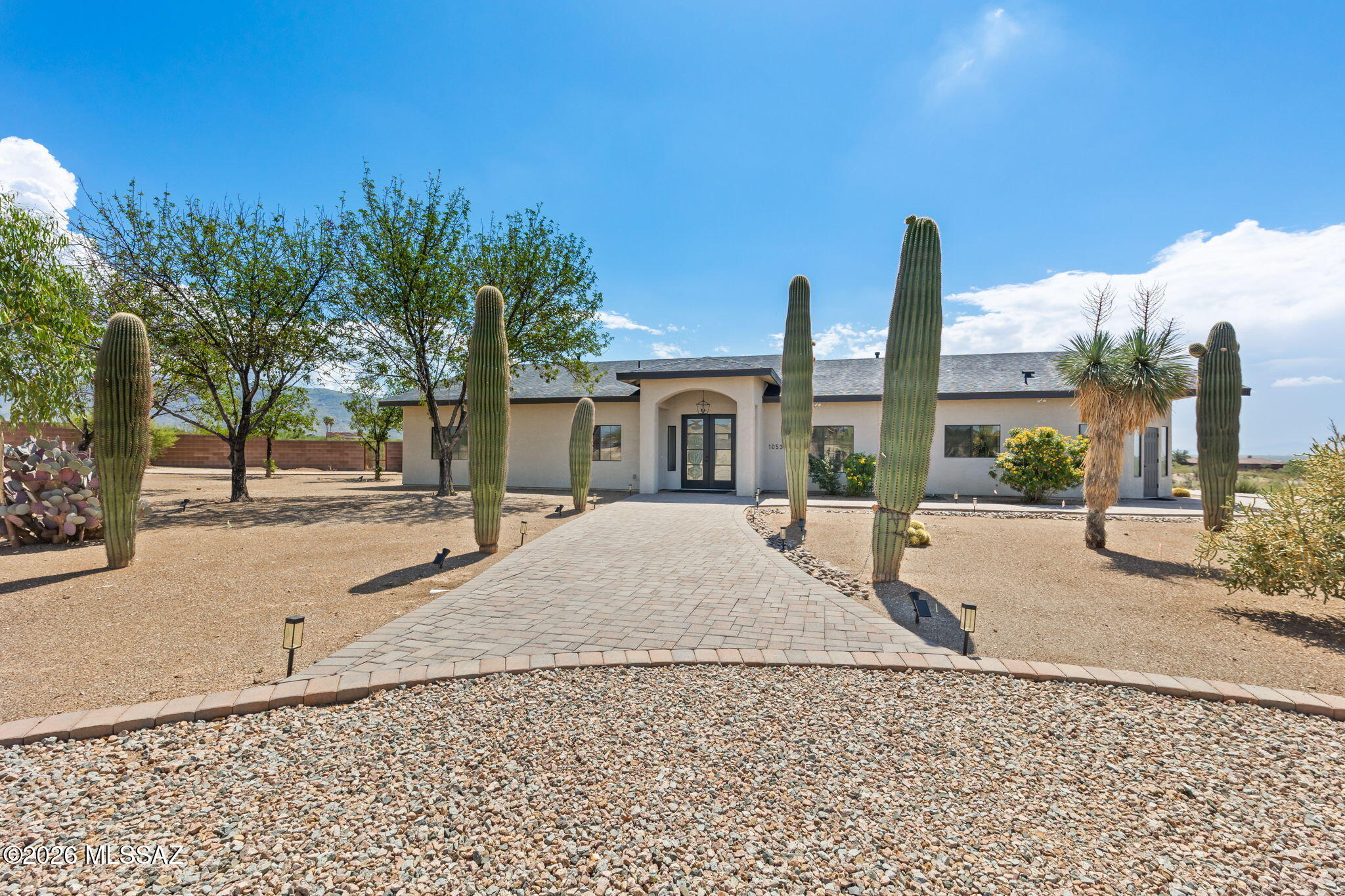 Private Gated Desert Estate on 3.3 Acres with Resort-Style Living! Tucked away behind the gates of an intimate four-home enclave, this beautifully renovated desert estate offers a rare combination of privacy, panoramic mountain views, and modern luxury on more than 3.3 acres--all with no HOA. From the moment you arrive, you'll appreciate the peaceful setting and expansive open space that surrounds the property. Inside, the thoughtfully redesigned single-level home blends contemporary finishes with comfortable everyday living. Large windows frame the surrounding mountains while filling the home with natural light, creating an inviting atmosphere throughout. The gourmet kitchen serves as the heart of the home, featuring custom cabinetry, quartz countertops, premium stainless-steel appliances and generous workspace for everything from casual family meals to entertaining guests. The spacious great room flows effortlessly to the outdoor living areas, making indoor-outdoor living seamless.

The primary suite provides a private retreat with a beautifully updated spa-inspired bath and direct access to the backyard, where the desert landscape becomes your everyday backdrop.


Step outside to experience what truly sets this property apart. The resort-style pool, expansive covered patio, and multiple outdoor gathering areas create the perfect setting for relaxing afternoons, sunset dinners, or entertaining family and friends beneath Arizona's spectacular skies. Panoramic mountain views surround the property in every direction, offering a sense of tranquility that's increasingly difficult to find.


The acreage provides room to breathe while offering flexibility for recreational vehicles, additional garages or workshops, future guest accommodations, or simply enjoying the privacy that comes with owning your own piece of the Sonoran Desert.


Despite its secluded feel, the home is just minutes from shopping, dining, golf, Davis-Monthan Air Force Base, and convenient access to Tucson's major employment centers like Raytheon.


Whether you're searching for a full-time residence, an executive retreat, or a lock-and-leave Arizona home, this exceptional property offers an uncommon opportunity to enjoy luxury living with space, privacy, and breathtaking desert beauty.
Property Highlights
    Private gated four-home enclave
    Over 3.3 acres of usable desert property
    No HOA
    Beautifully renovated throughout
    Resort-style pool and outdoor entertaining areas
    Panoramic mountain views
    Single-level floor plan
    Gourmet kitchen with premium finishes\
    Spacious primary suite
    Room for RVs, recreational vehicles, workshop, or future expansion (subject to applicable approvals)
    Convenient access to shopping, dining, golf, and Davis-Monthan Air Force Base