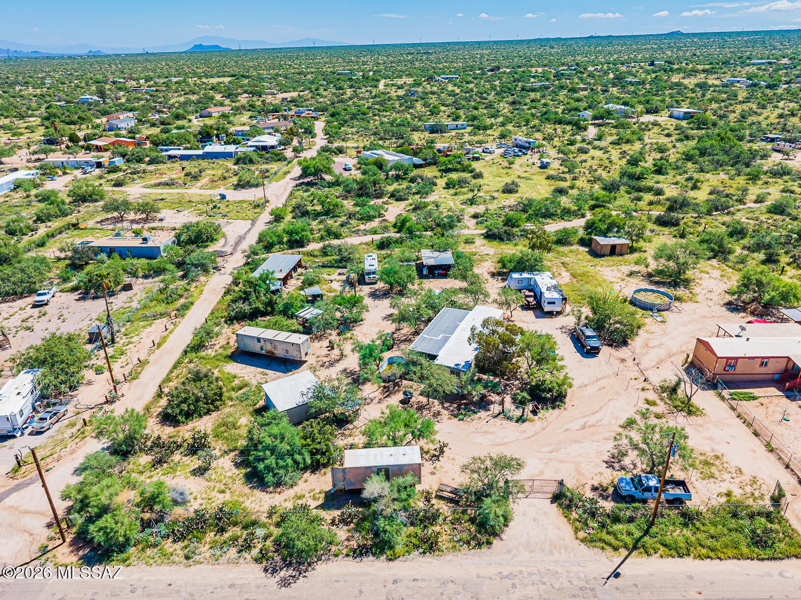 Welcome to your own piece of the Arizona desert! This 1.11-acre horse property in Three Points features a renovated, move-in-ready 2BR/2BA manufactured home, carports, storage, and plenty of open land for animals, RVs, toys, or future improvements. Two travel trailers on the property offer additional income potential. Enjoy beautiful desert views, incredible sunrises and sunsets, paved-road access, and a peaceful community near Kitt Peak and approximately 25 minutes from the freeway. Perfect for those wanting acreage, animals, or a place to live while building their dream home. Seller is willing to install new carpet in both bedrooms prior to closing with an acceptable offer.